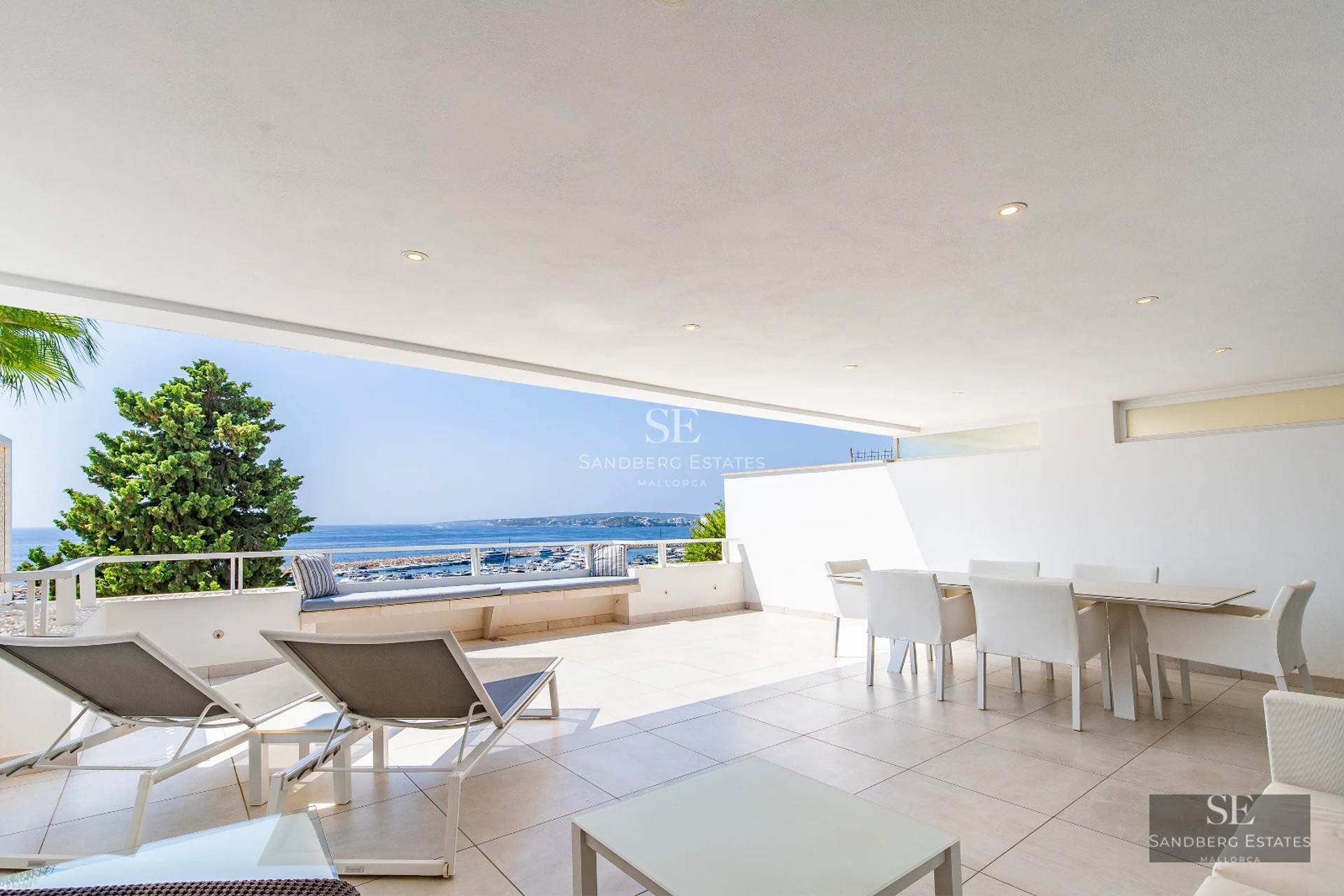 Exterior view of a modern villa featuring a reflective pool, large windows, and minimalist design. Manicured garden and contemporary architecture.
