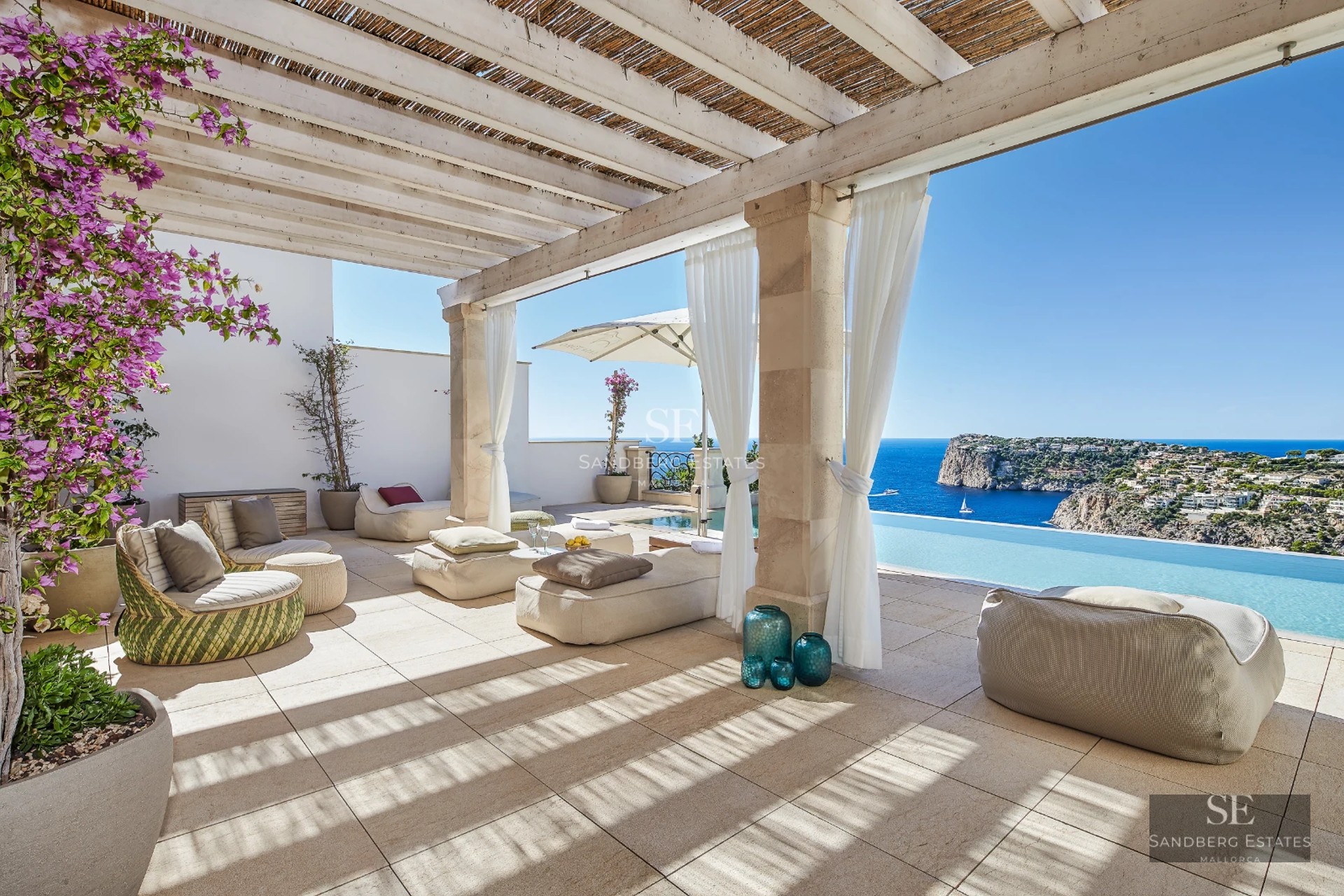 Exterior view of a modern villa with an infinity pool, lush garden, and spacious terraces. Elegant architecture and landscaping.
