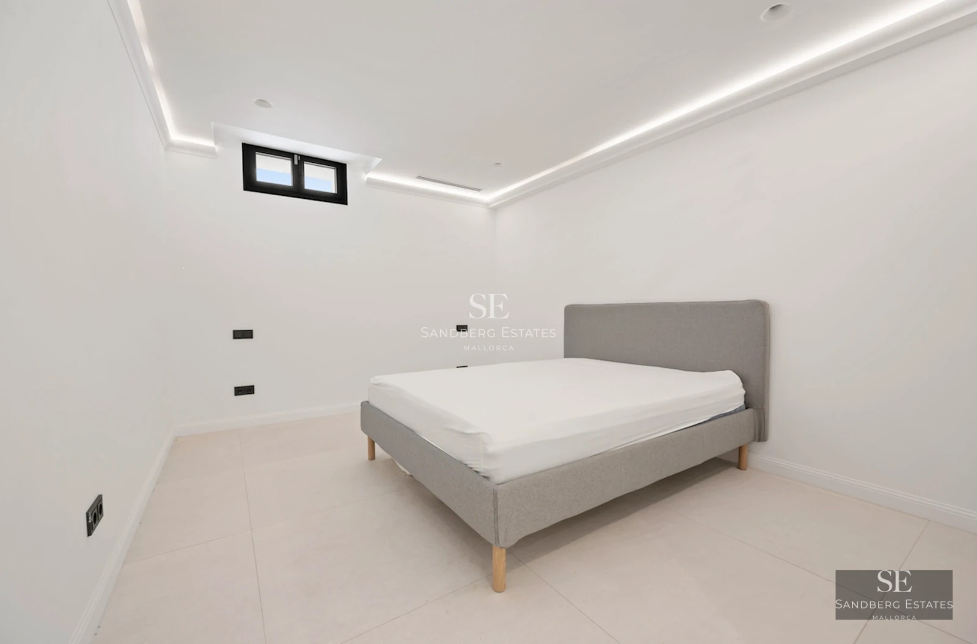 Exterior view of modern villa featuring an infinity pool, large windows, minimalist architecture, and lush garden.