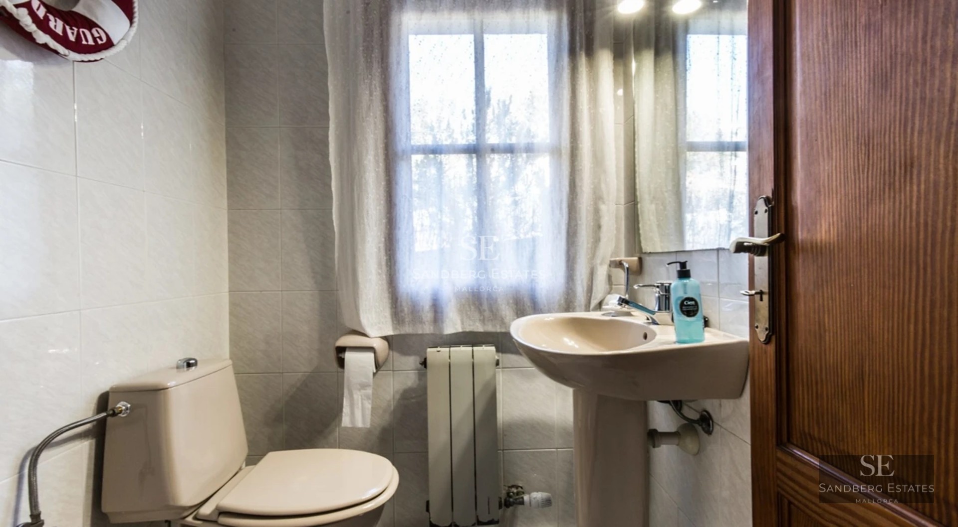 Spacious living room with large windows, modern sofas, coffee table, and panoramic sea views. Elegant and bright design.