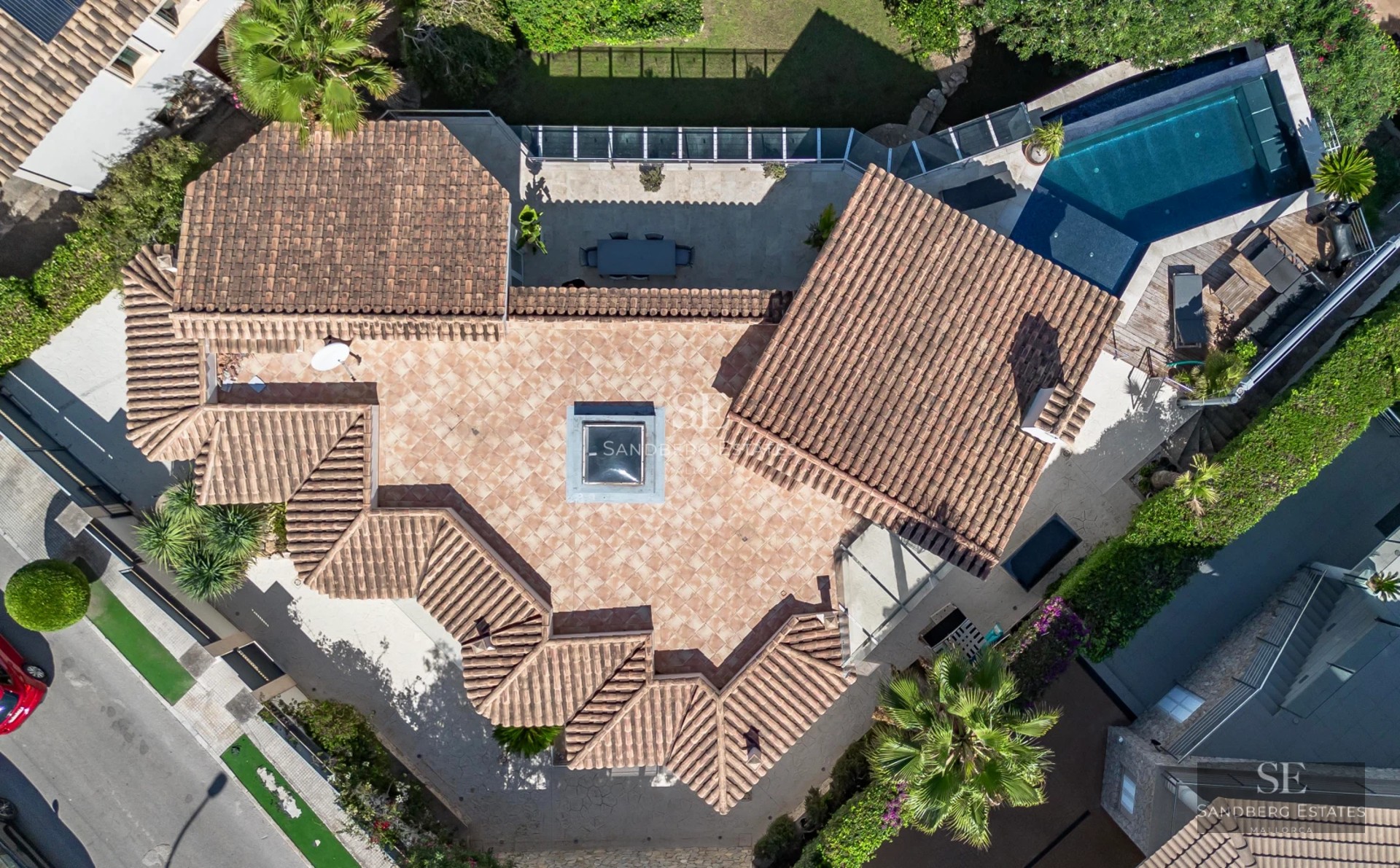 Exterior view of a modern villa featuring an infinity pool, lush gardens, and contemporary architectural design. Soft ambient lighting.