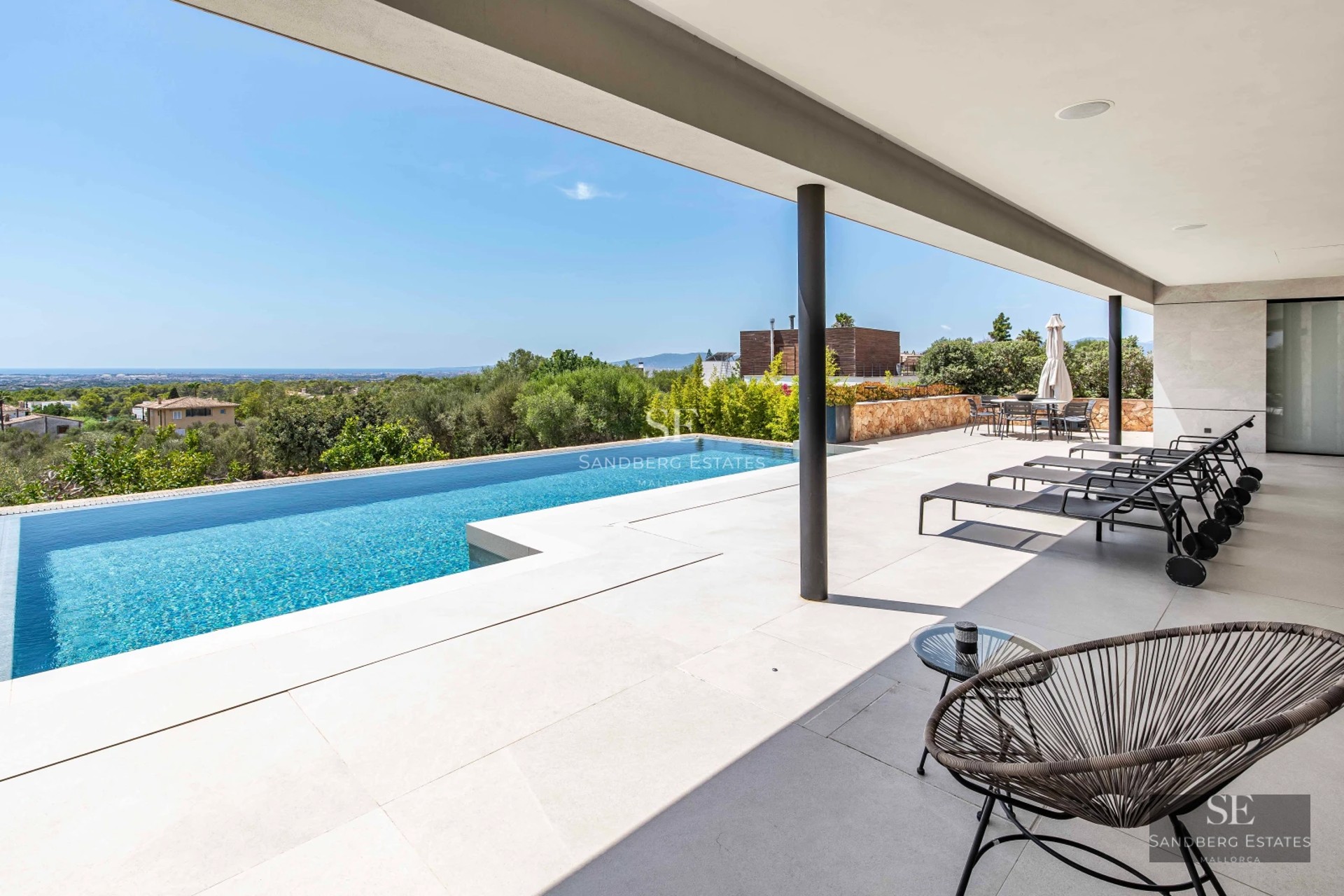 Exterior of modern villa with infinity pool, lush garden, and minimalist architecture. Warm sunset lighting.