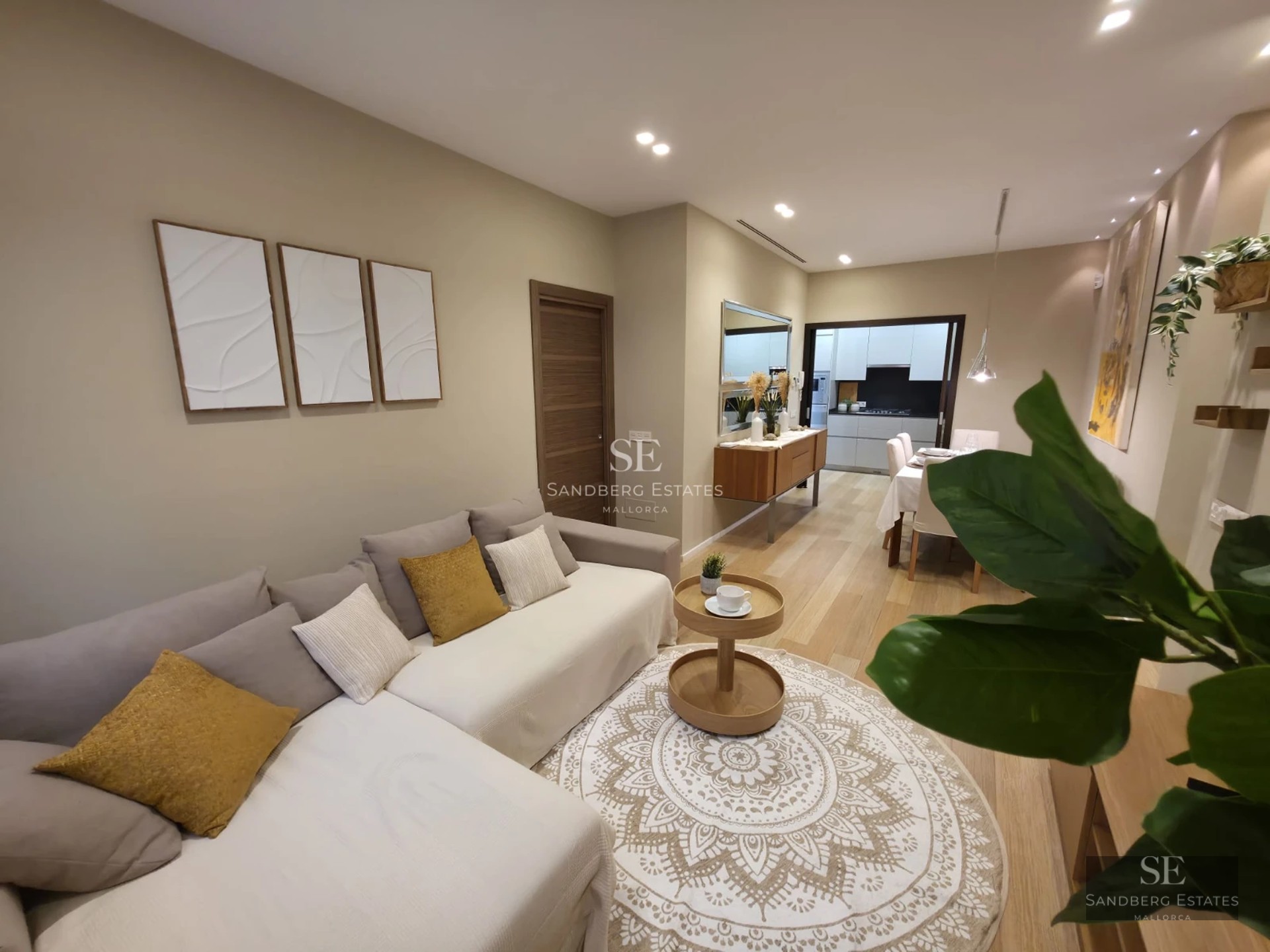 Exterior view of a modern villa with infinity pool, wooden deck, and large glass windows. Lush garden with tropical vegetation.