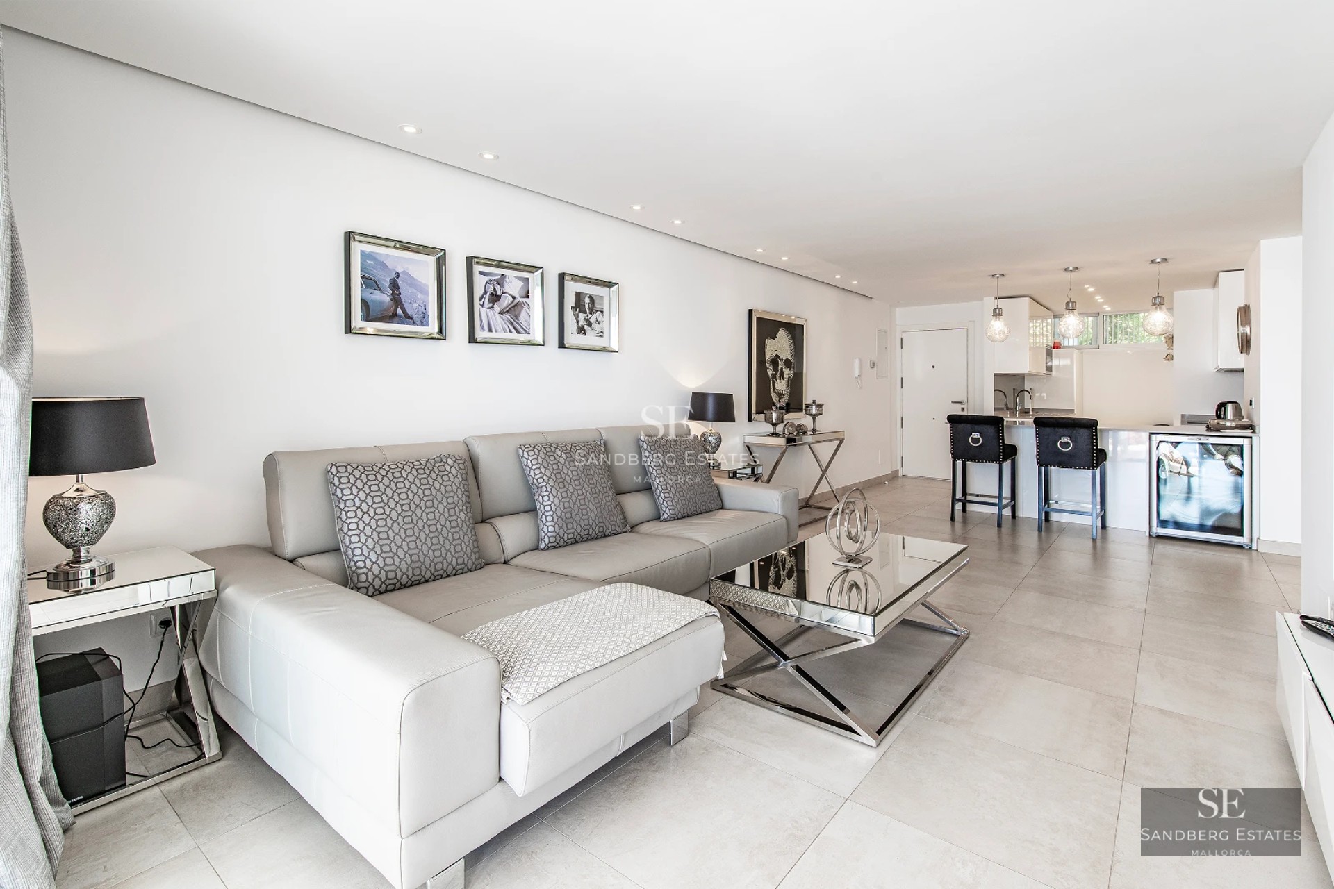 Panoramic view of a modern villa with infinity pool, sun loungers, and lush greenery. Minimalist design with large windows.