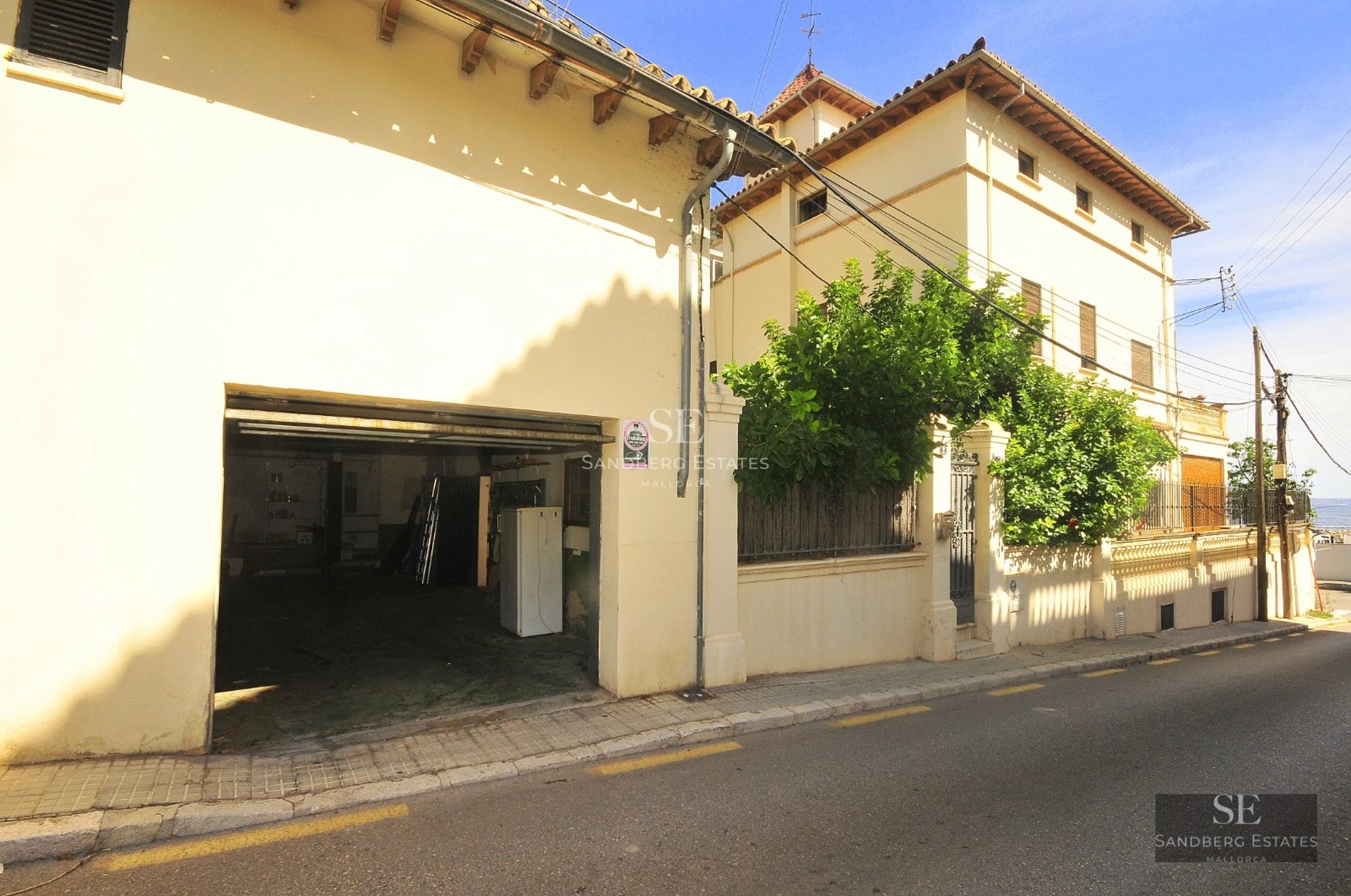 Exterior view of a modern villa with infinity pool, lush garden, and minimalist architecture. Warm ambient lighting.