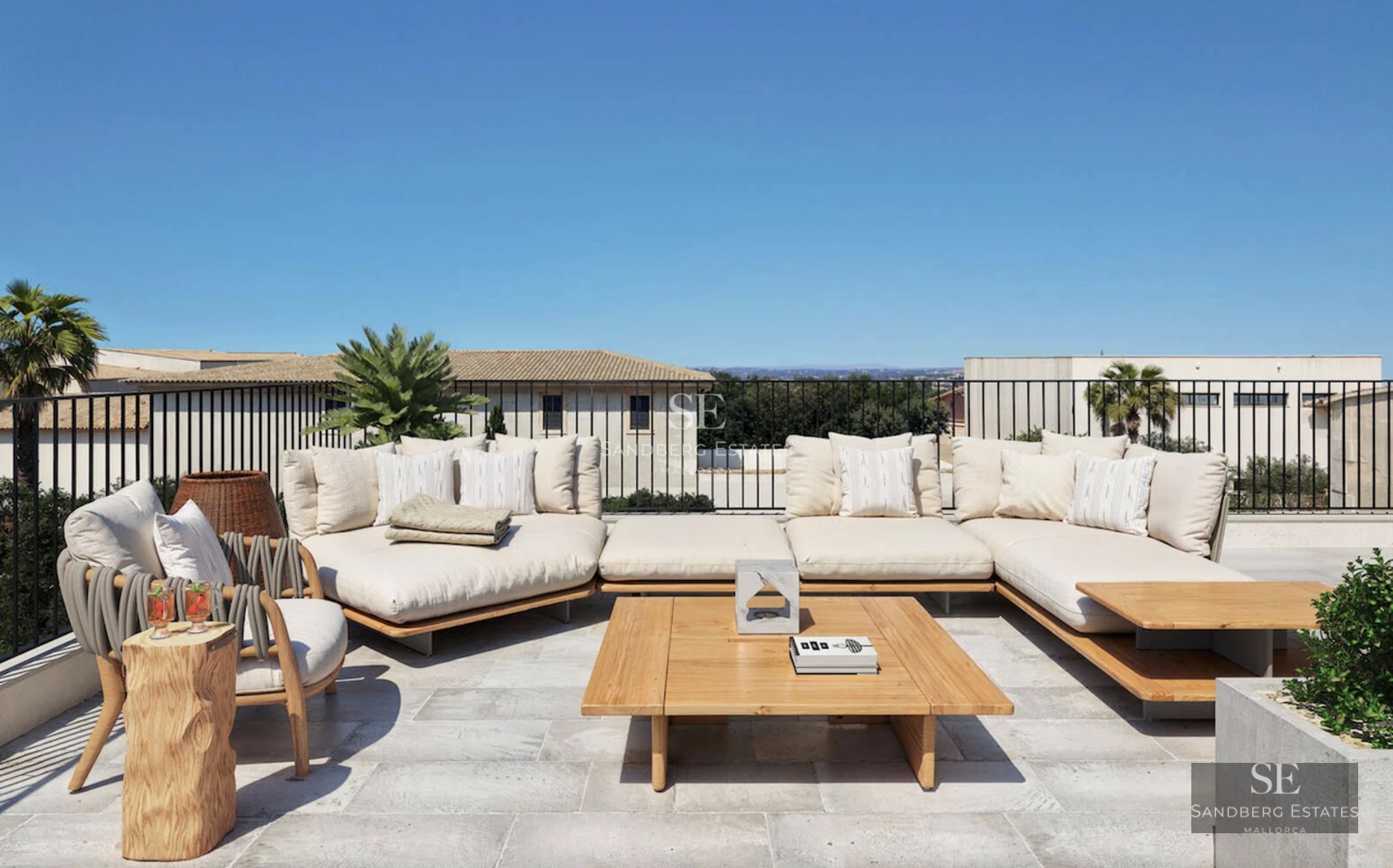 Spacious living room with large windows, sea views, modern furniture, and balcony access. Bright and airy.