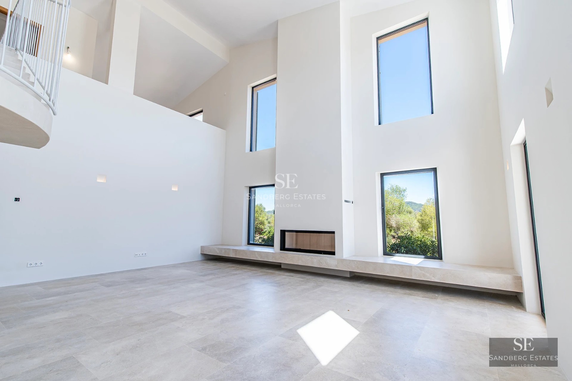 Aerial view of a modern villa featuring an infinity pool, spacious terraces, and lush garden. Contemporary architectural design with clean lines.