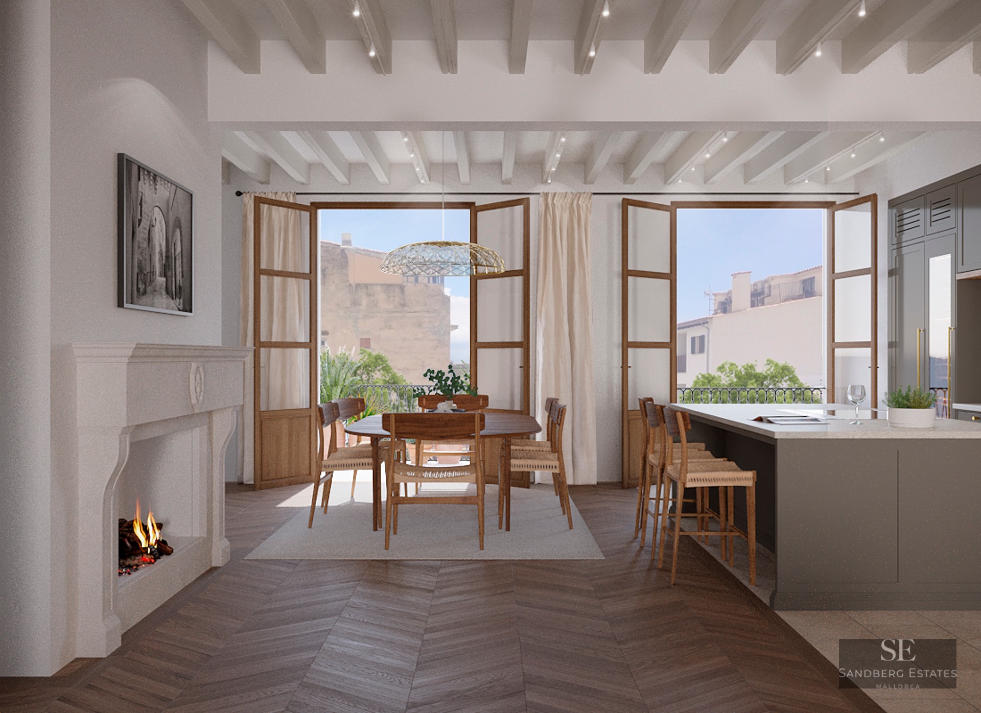 Open-plan dining room with wood chevron floors, a classic stone fireplace, and French doors opening to a balcony.
