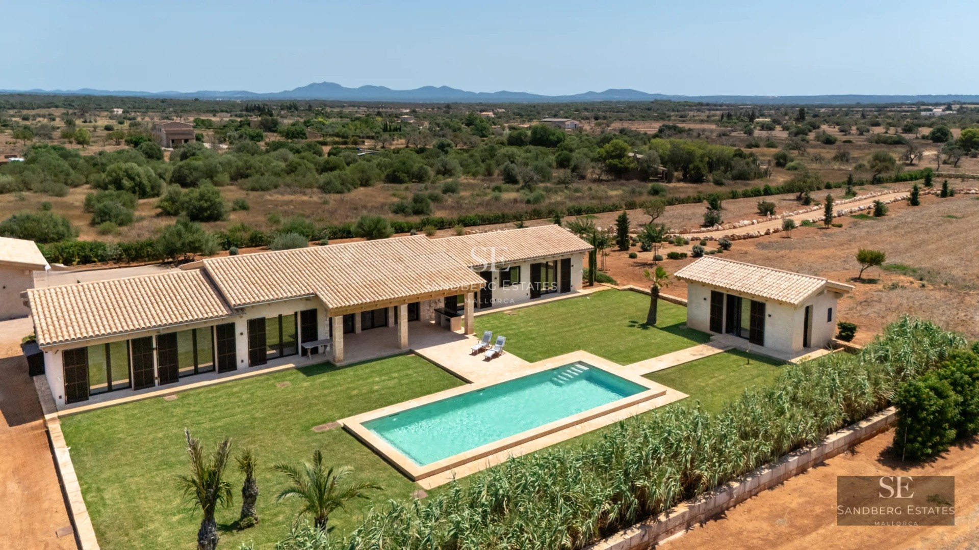 Spacious living room with panoramic windows, light wood floors, and modern decor. Stunning sea views.