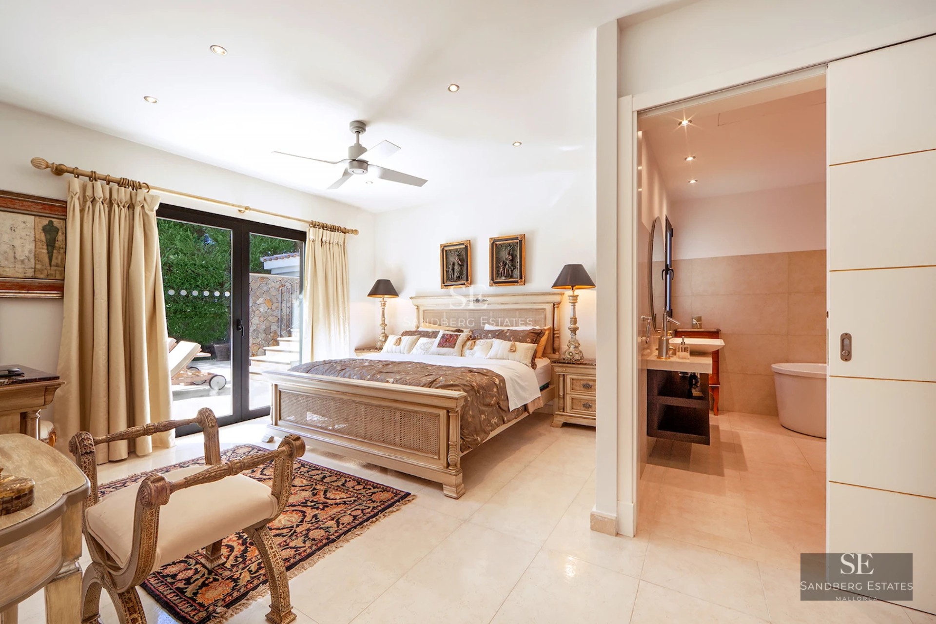 Spacious living room with window walls, terrace with sea view, modern design, light wood floors, minimalist decor.