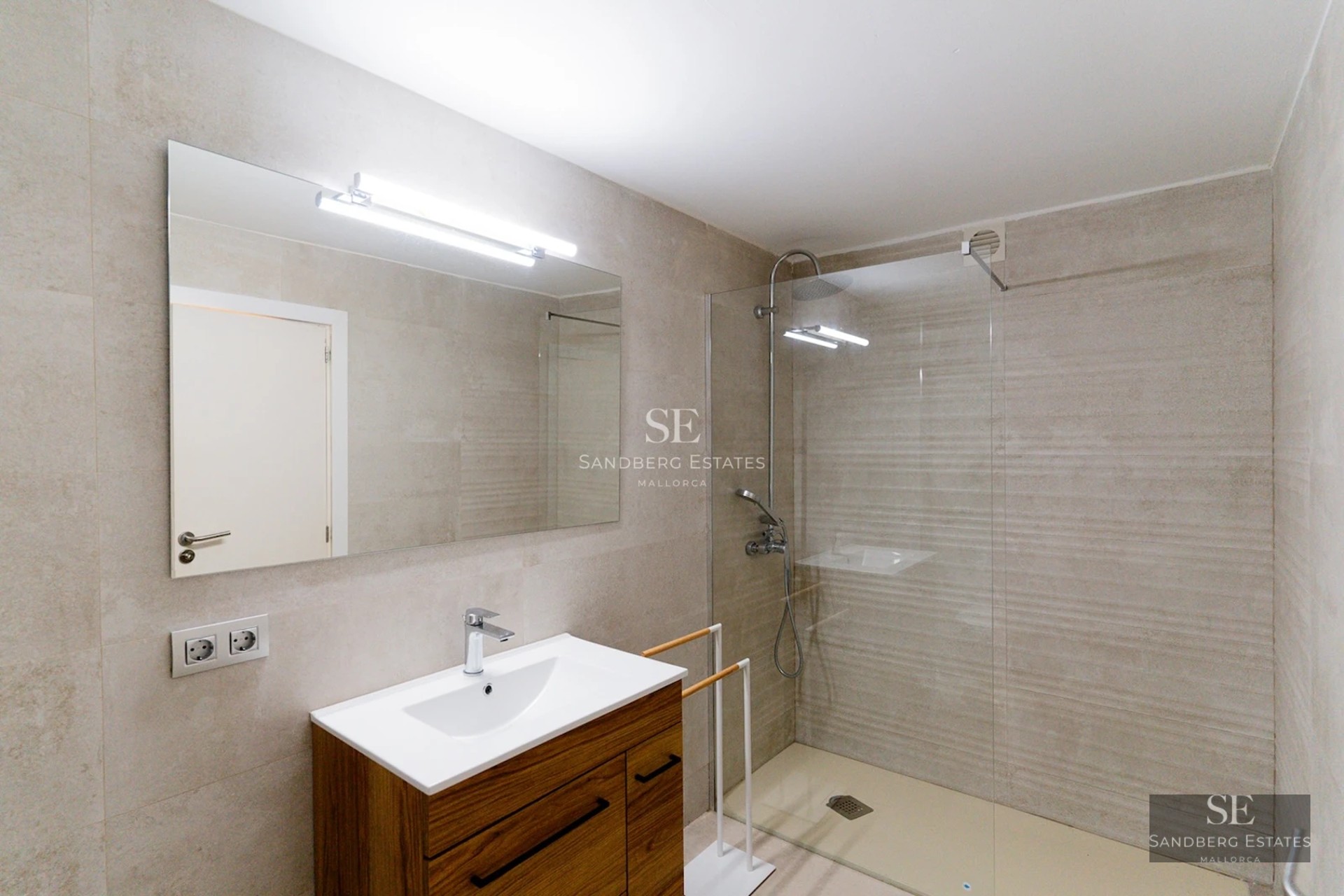 Exterior view of a modern villa featuring an infinity pool, surrounded by greenery and minimalist architectural design.