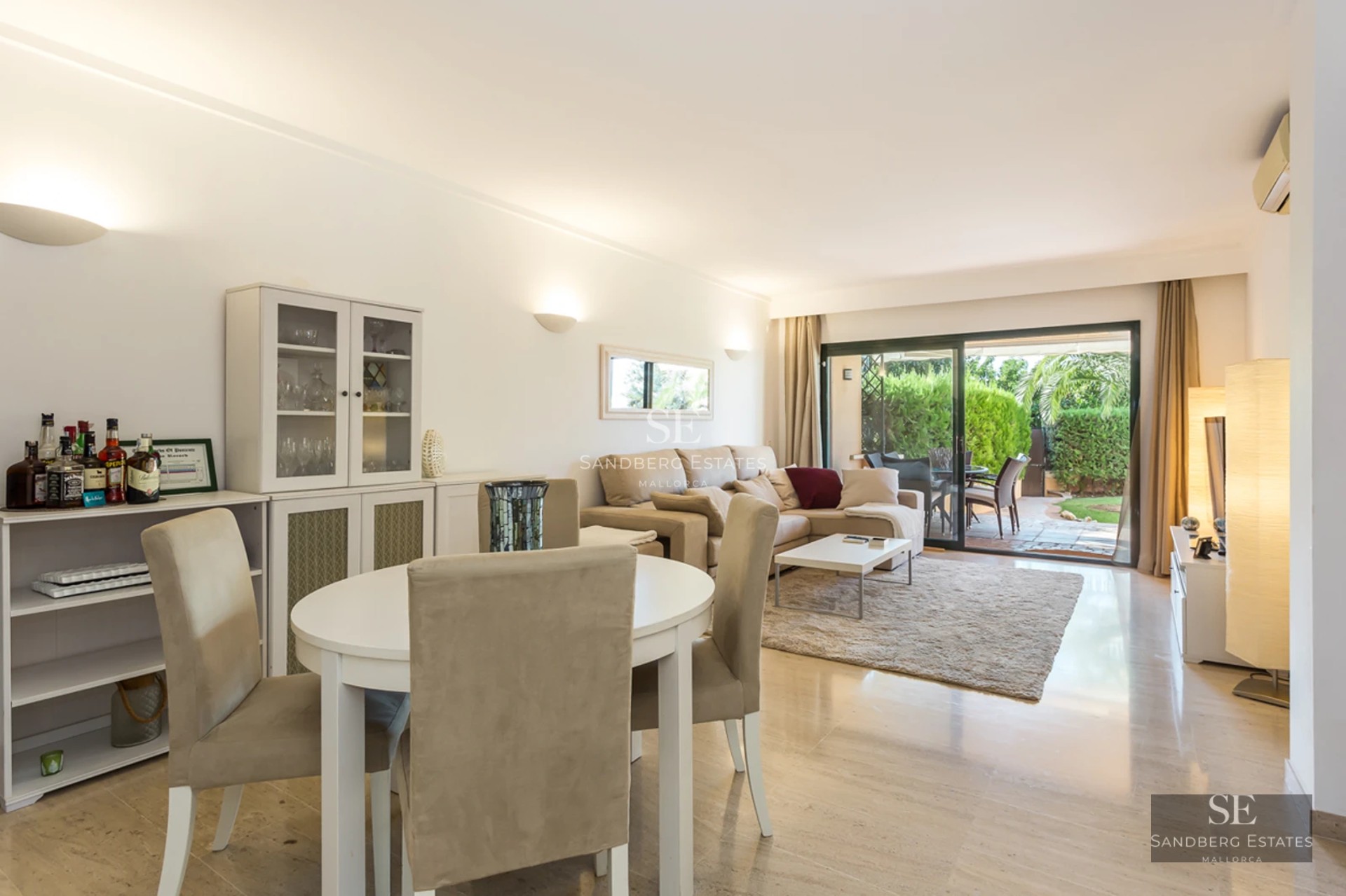 Modern apartment with a glazed balcony overlooking the sea. Minimalist design, light wood flooring and elegant furniture.