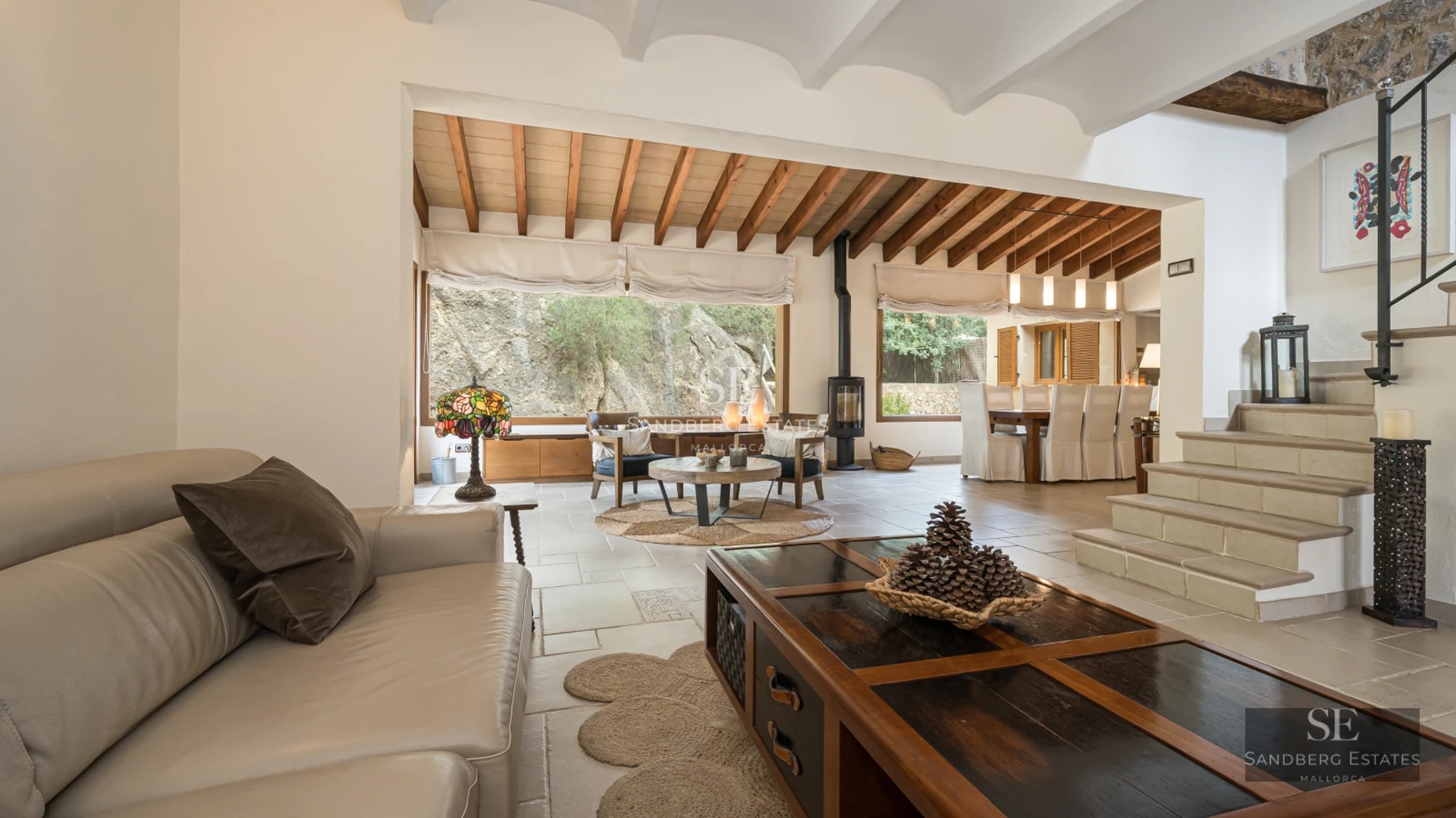 Spacious living room with natural light, modern fireplace, floor-to-ceiling windows & terrace access. Minimalist decor & designer furniture. Panoramic views.