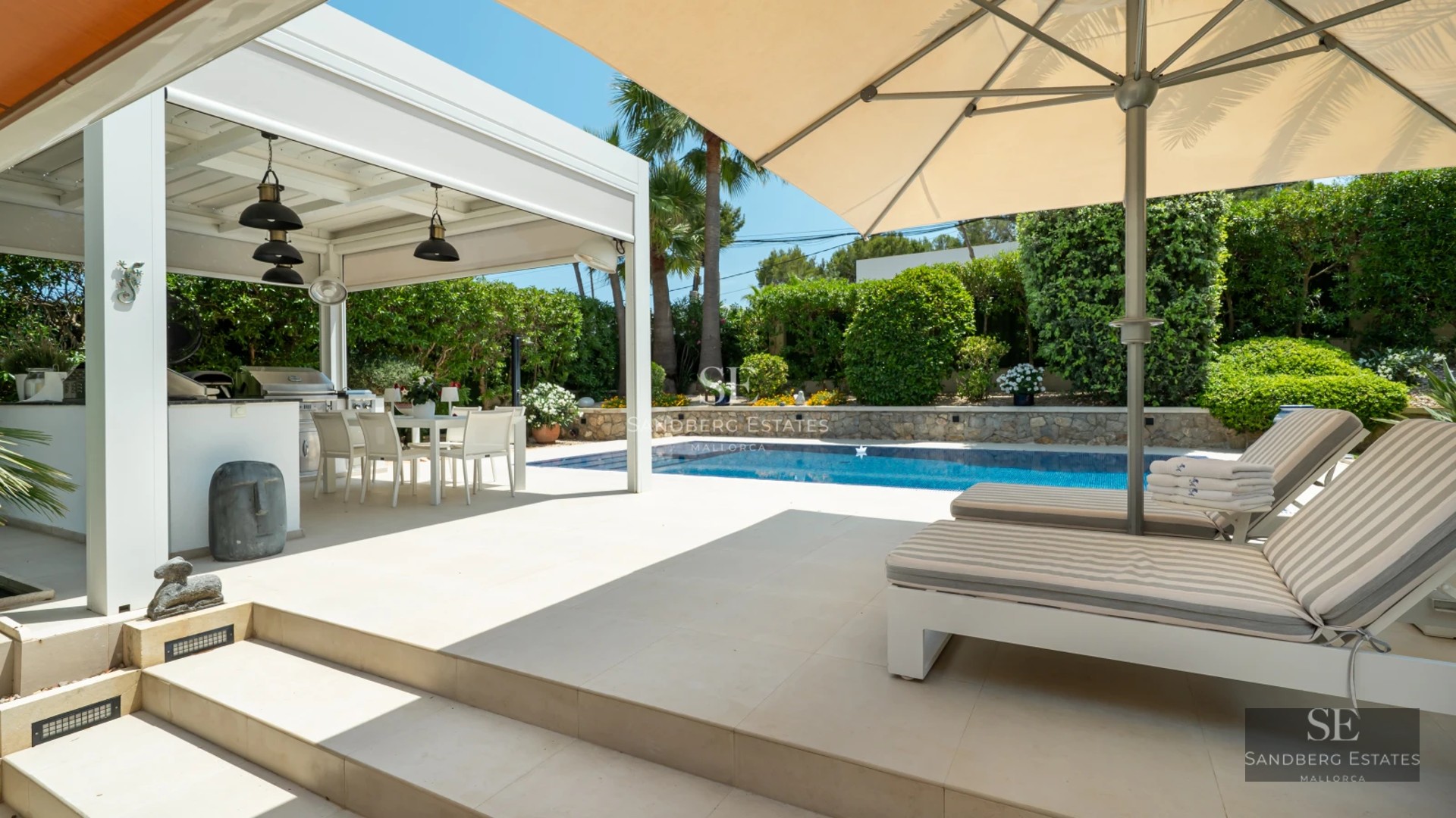 Bright living room with large windows, light wood floors, a modern fireplace, and contemporary design furniture. Panoramic views.