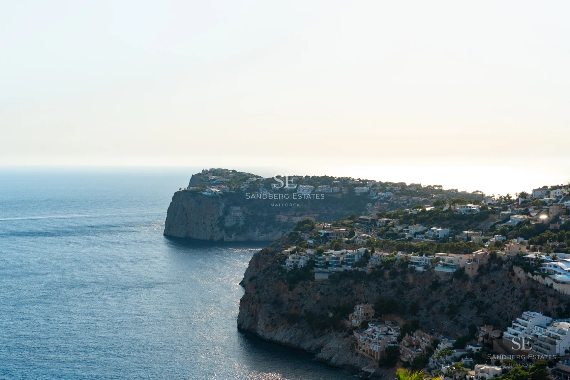 Spacious terrace with infinity pool and panoramic sea views from luxury apartment. Modern furniture and elegant design.