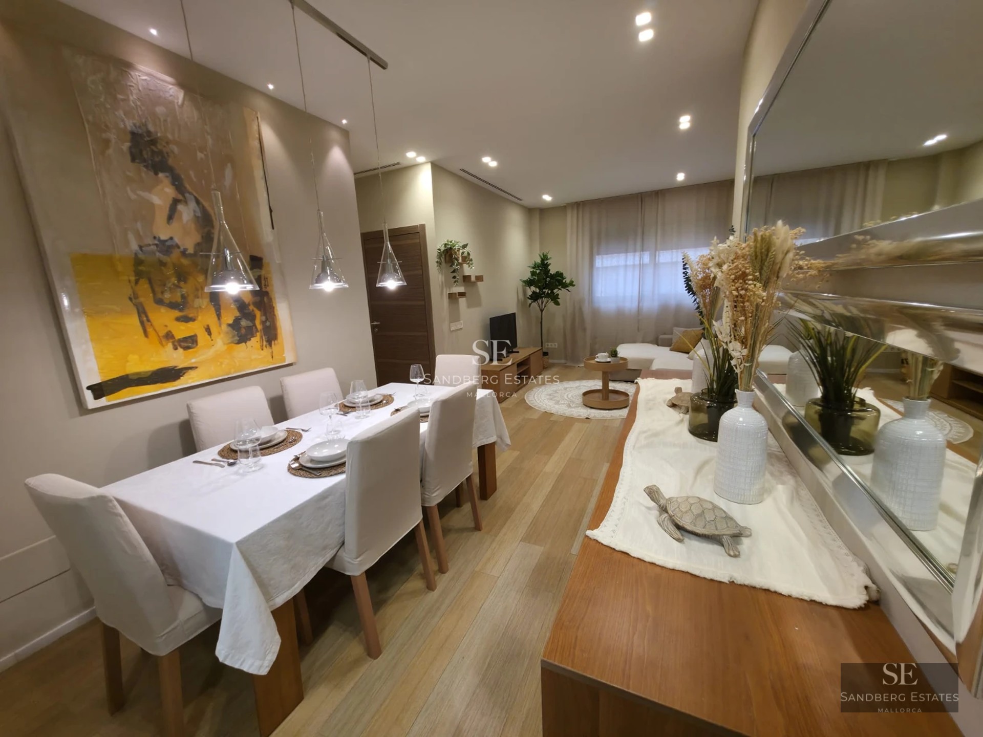 View of a modern villa with infinity pool, lush gardens, and spacious terraces. Minimalist design and abundant natural light.