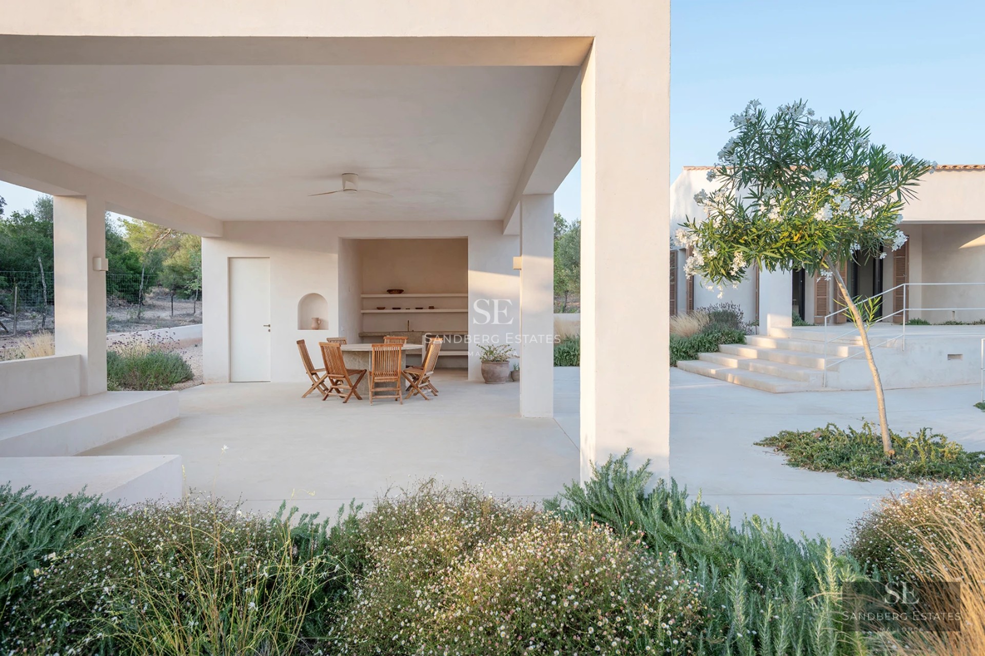 Modern exterior featuring a reflective pool, light stone facade, expansive windows, and lush gardens. Impeccable landscaping.