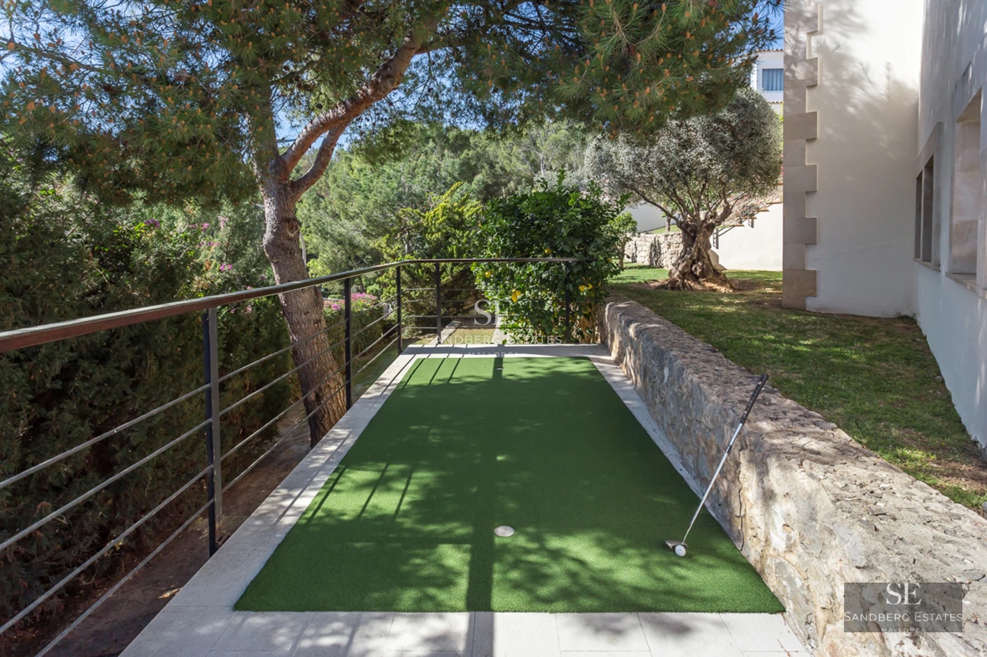 Bright living room with large windows, beige sofa, modern fireplace, and panoramic sea views. Elegant and minimalist design.