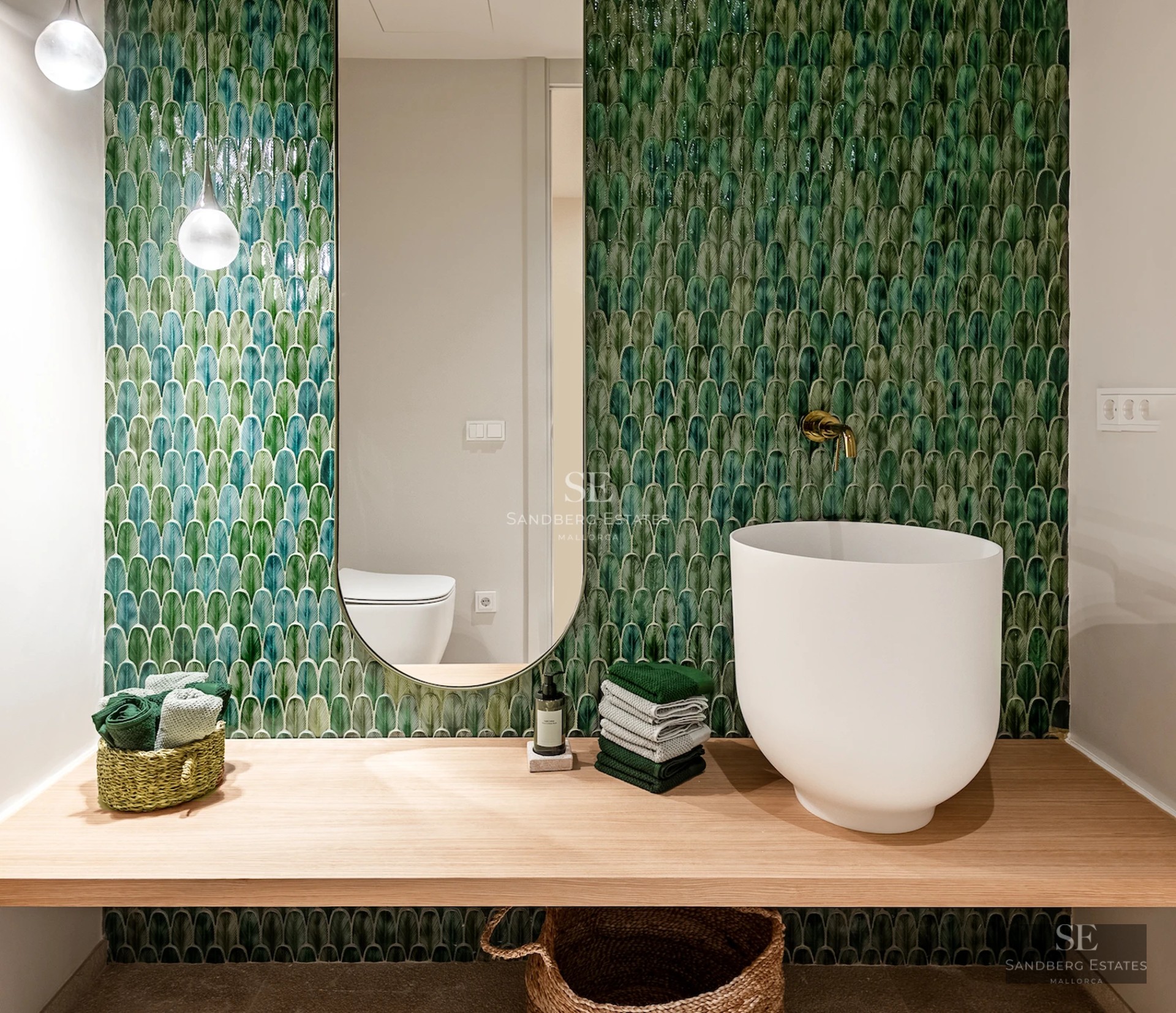 Bright interior with large windows, light wood floor, modern gray sofa and panoramic sea views. Minimalist and elegant design.