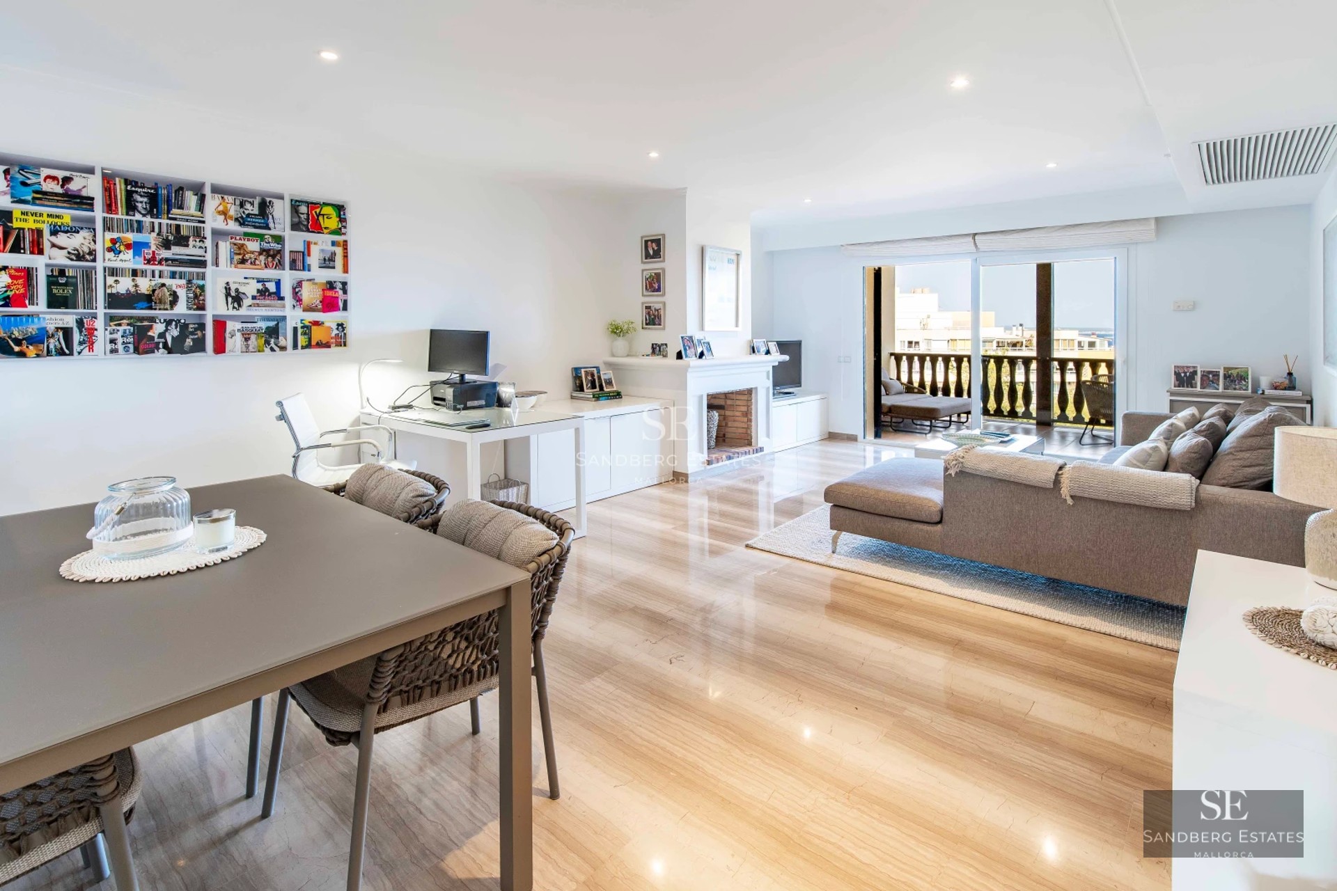 Spacious terrace with pool, sun loungers and panoramic views. Modern design with wooden floors and elegant furniture.