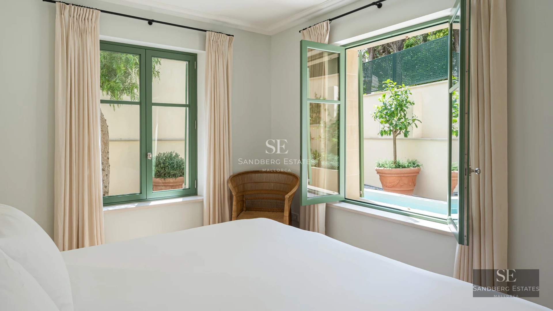 Exterior of a modern villa with a pool, large windows, and lush gardens. Minimalist and elegant design.