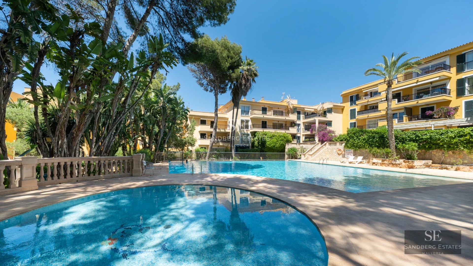 Exterior view of modern villa with reflecting pool, expansive garden, and minimalist architecture. Soft ambient lighting.