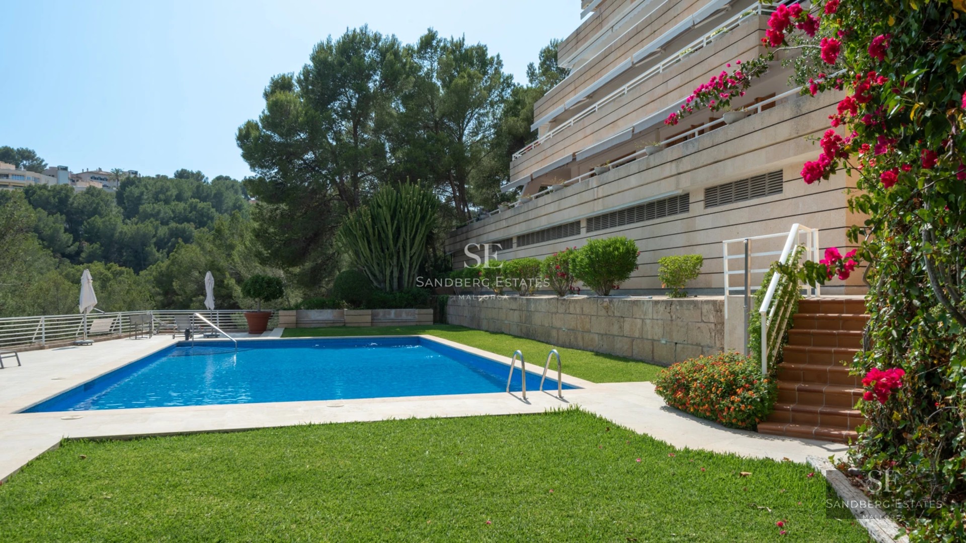Exterior view of a modern villa with infinity pool, lush gardens, and spacious terraces. Elegant architectural design.