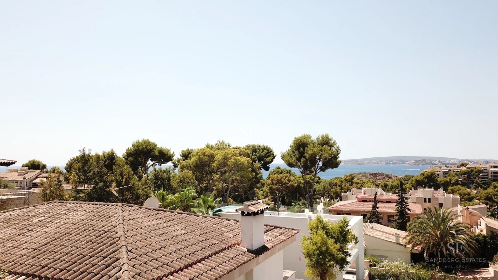 Spacious terrace with sea view. Modern design, elegant outdoor furniture, and infinity pool.