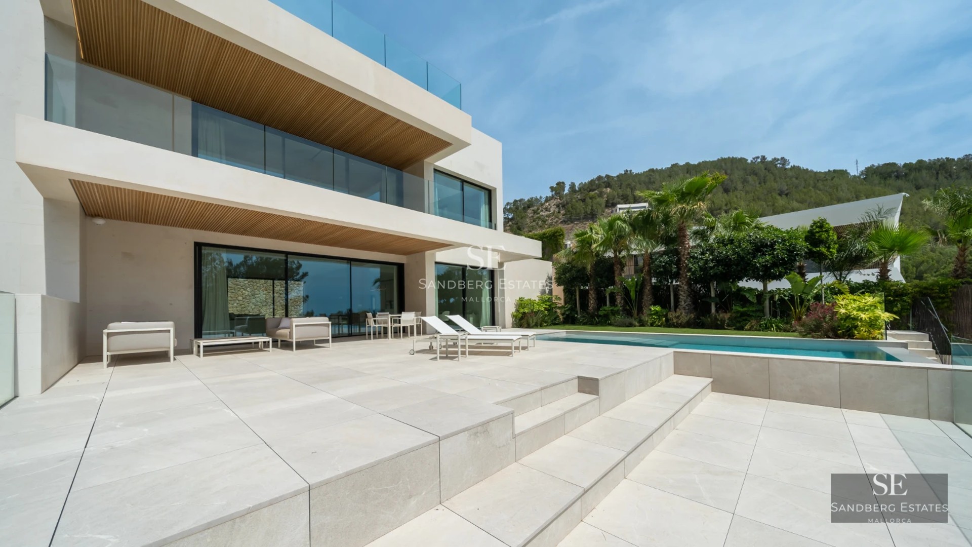 Spacious terrace with infinity pool, sun loungers, and panoramic views. Modern design, abundant natural light, high-quality materials.