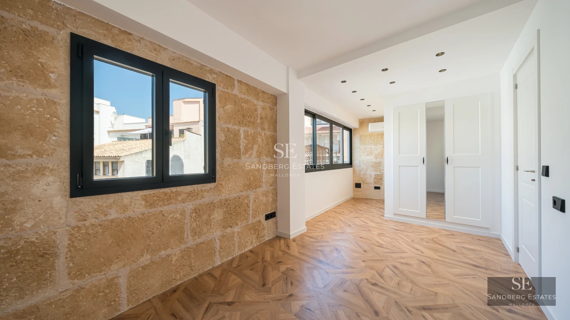 Exterior view of modern villa with infinity pool, wooden deck, lush garden, and large windows that flood the space with natural light.