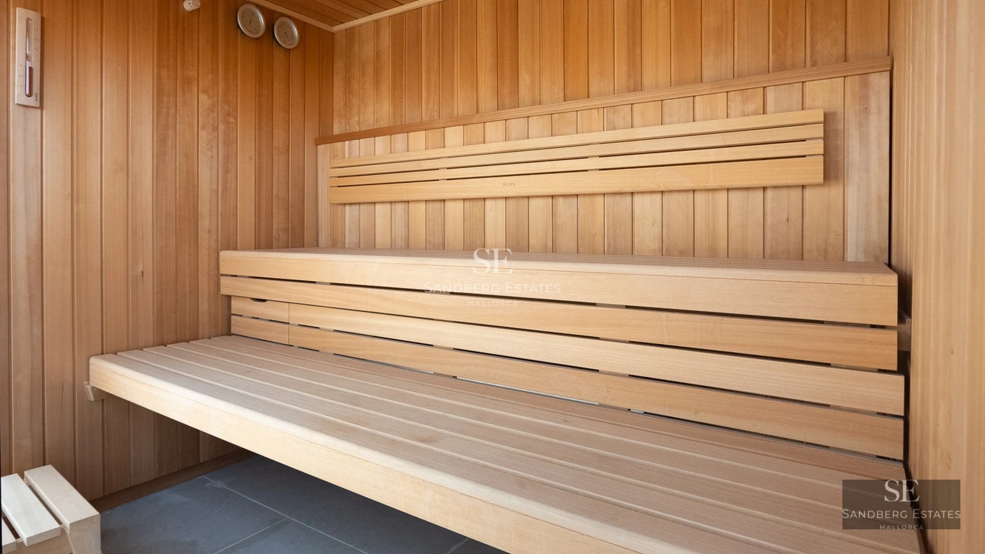 Exterior view of modern villa with pool, garden, and large windows. Minimalist architecture. Clear sky.