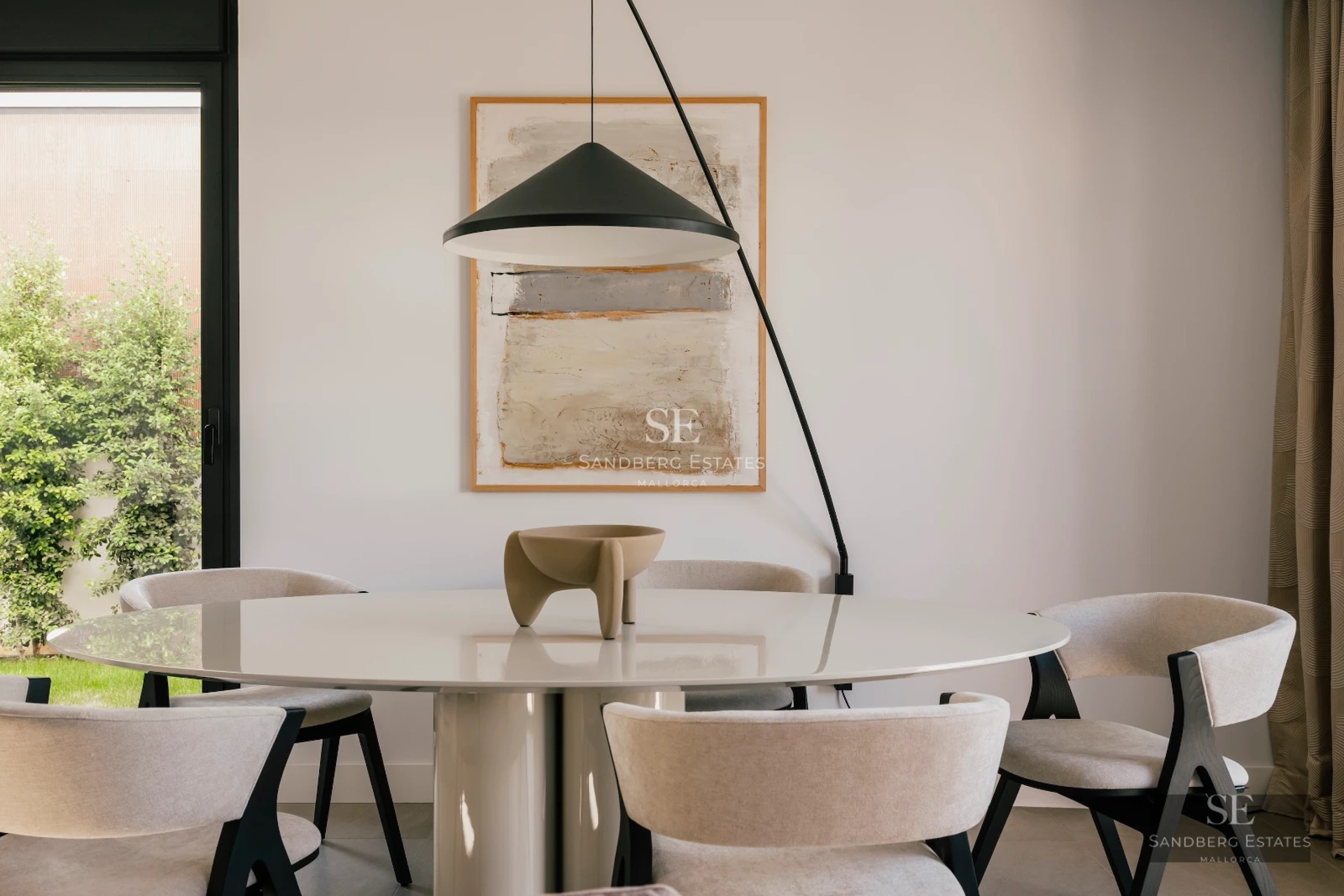 Spacious living room with panoramic windows, modern and elegant design, and breathtaking sea views. Natural and warm lighting.