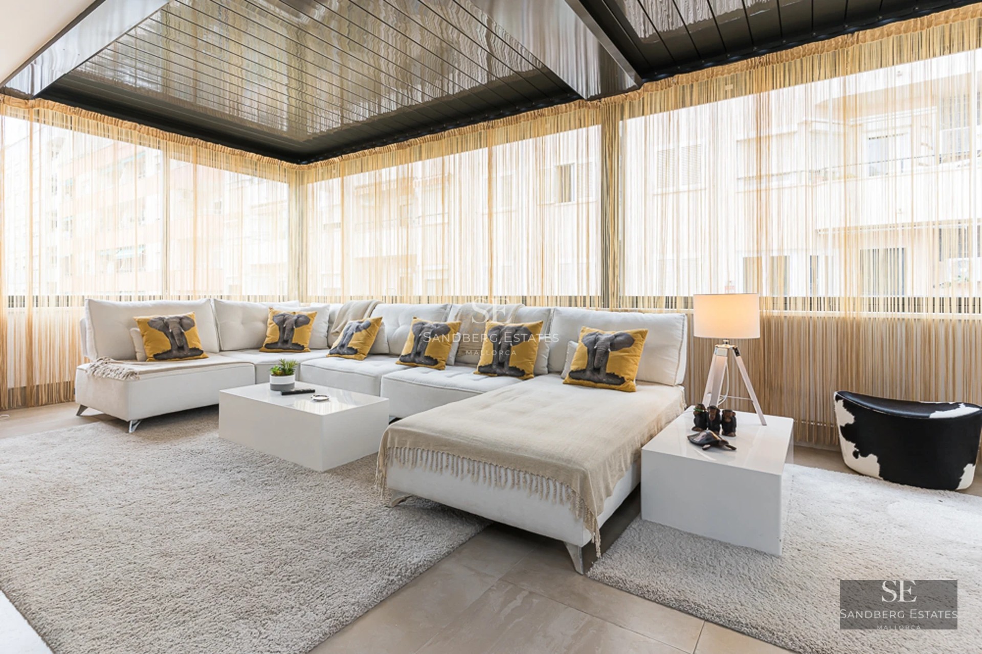 Spacious terrace with pool and sea views. Modern design with sun loungers, umbrellas, and lush vegetation. Ideal for relaxation.