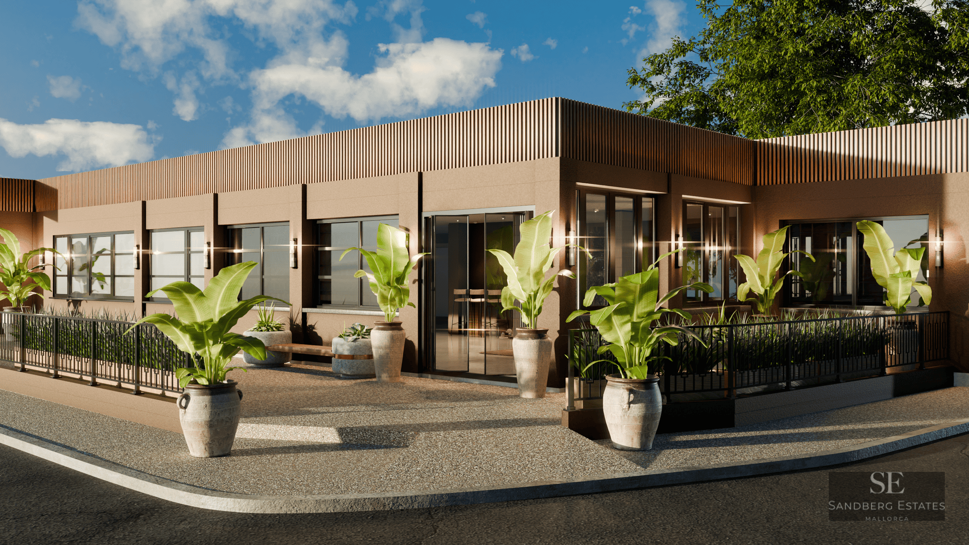 Modern building exterior featuring large potted tropical plants and wooden slat detailing under a bright blue sky.