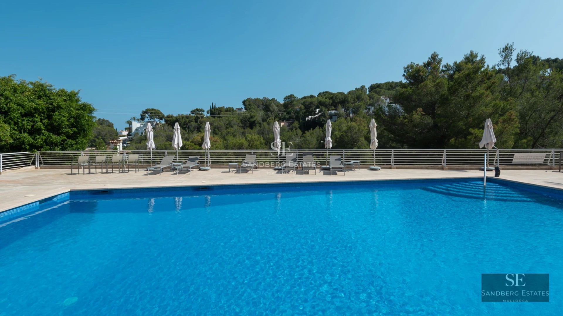 Spacious living room with large windows, light wood flooring and modern furniture. Panoramic ocean views from the terrace.