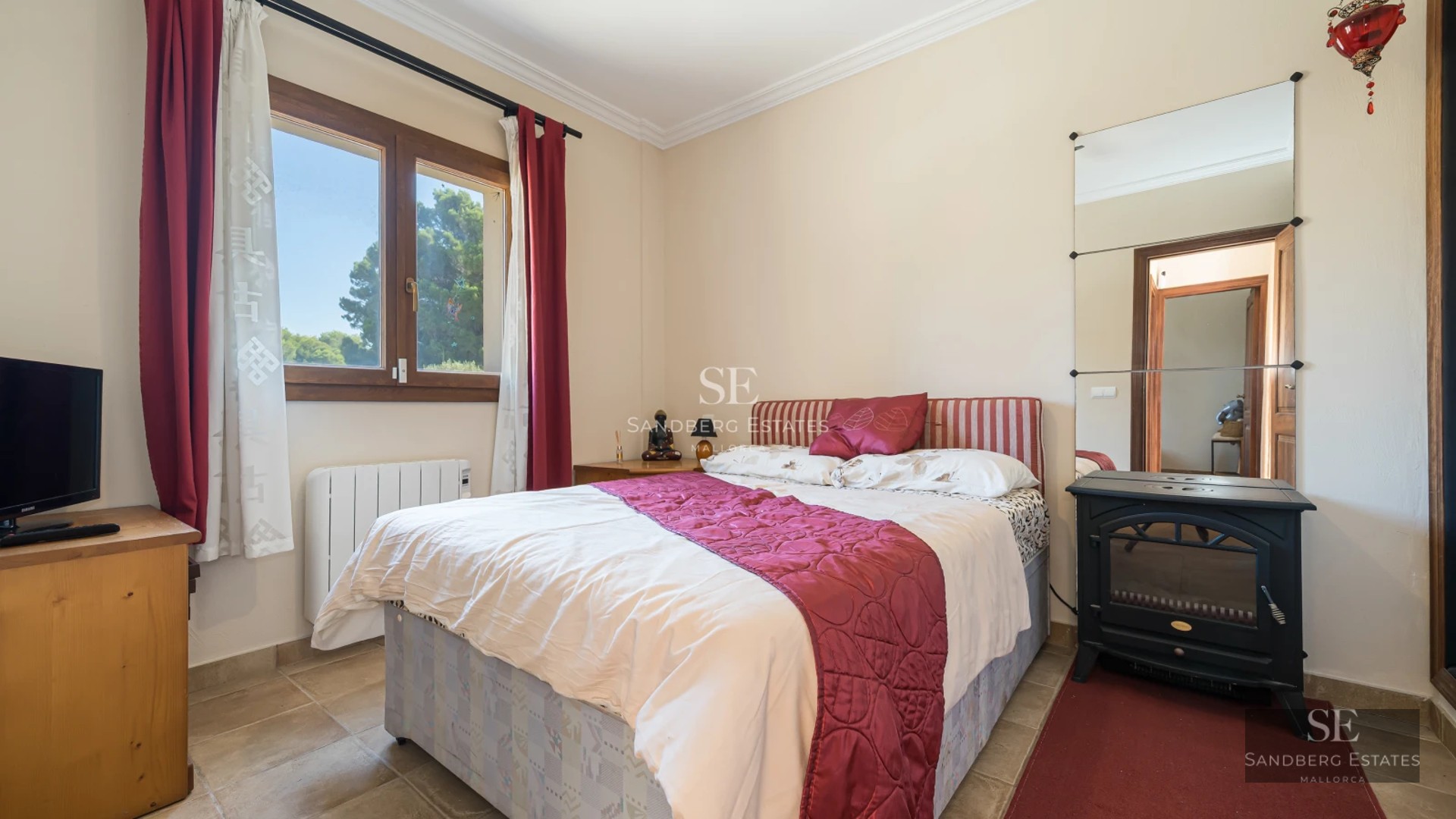 Spacious living room with floor-to-ceiling windows, light wood floors, modern furniture and panoramic views. Abundant natural light.