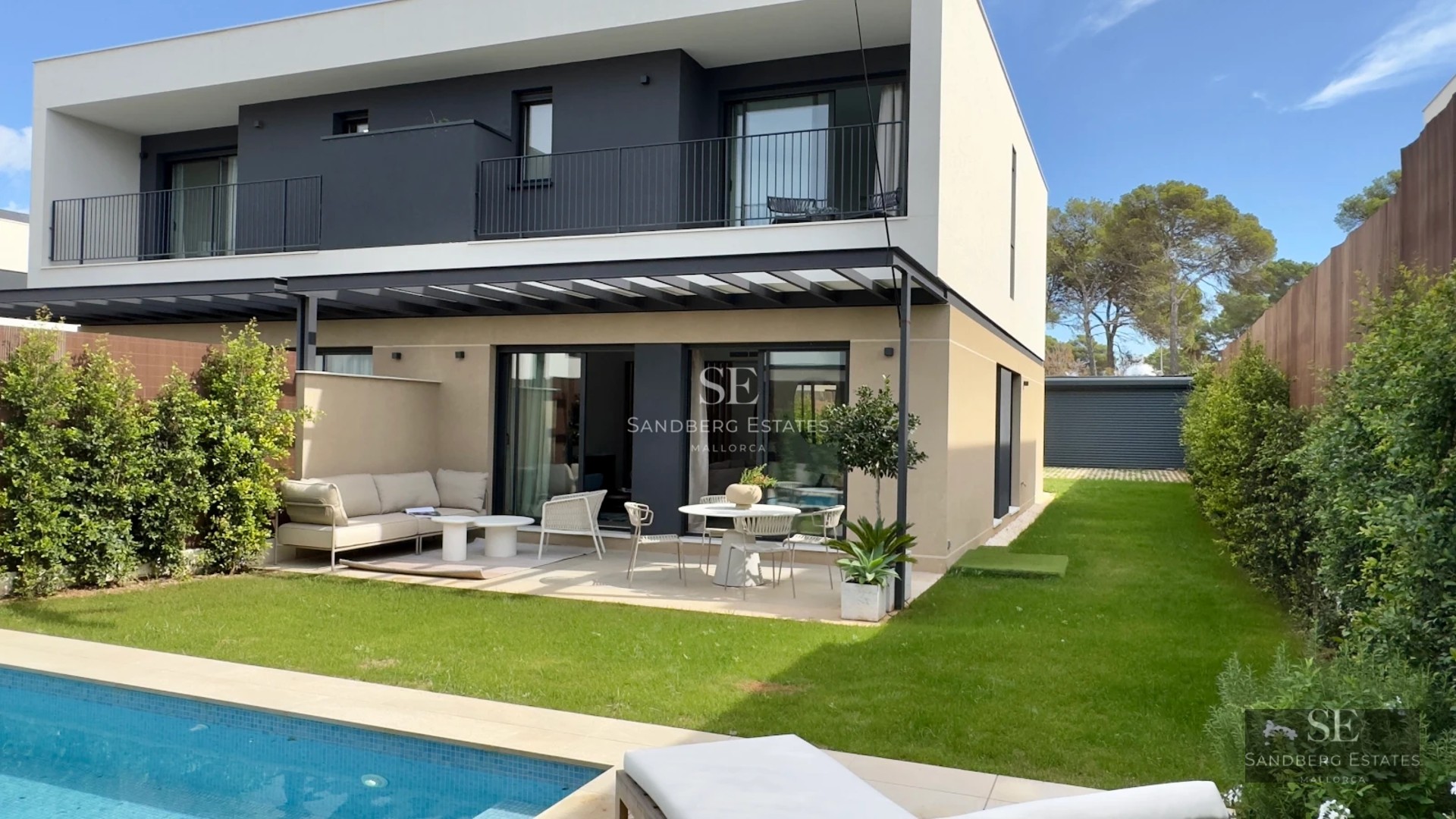 View of an elegant villa with a pool. Modern design, large windows, and high-quality finishes. Natural lighting and lush garden.