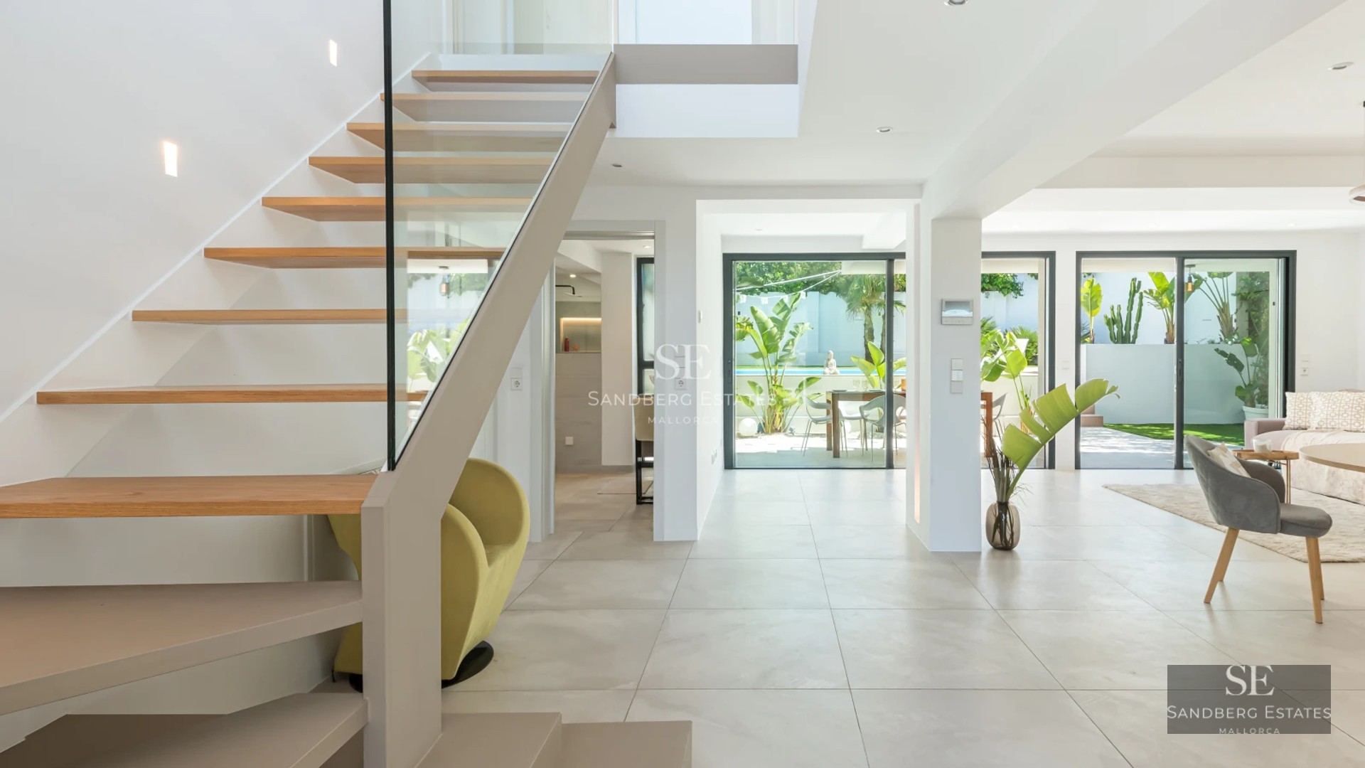 Exterior view of a modern villa with infinity pool, expansive terraces and minimalist architectural design. Lush garden.