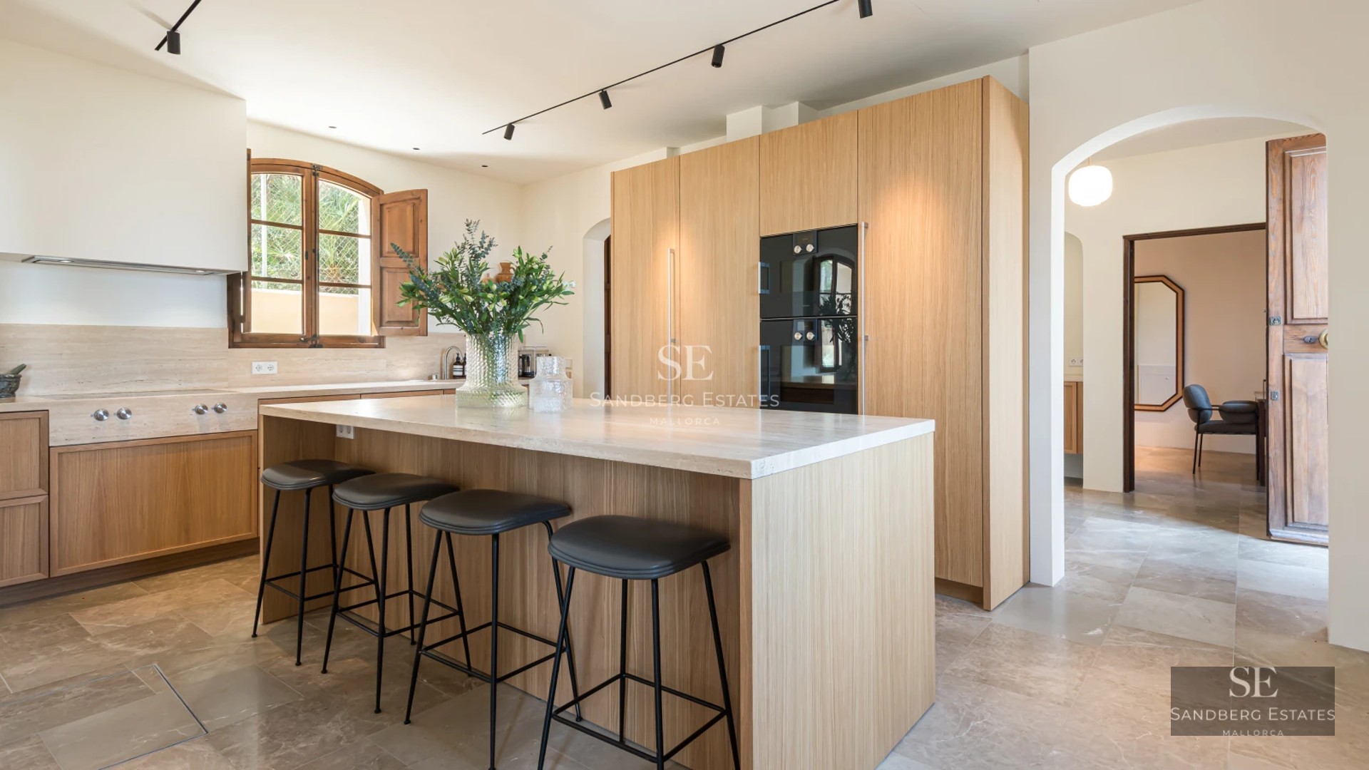 Exterior view of a modern villa featuring an infinity pool, garden, and spacious terraces. Minimalist architecture with large windows.
