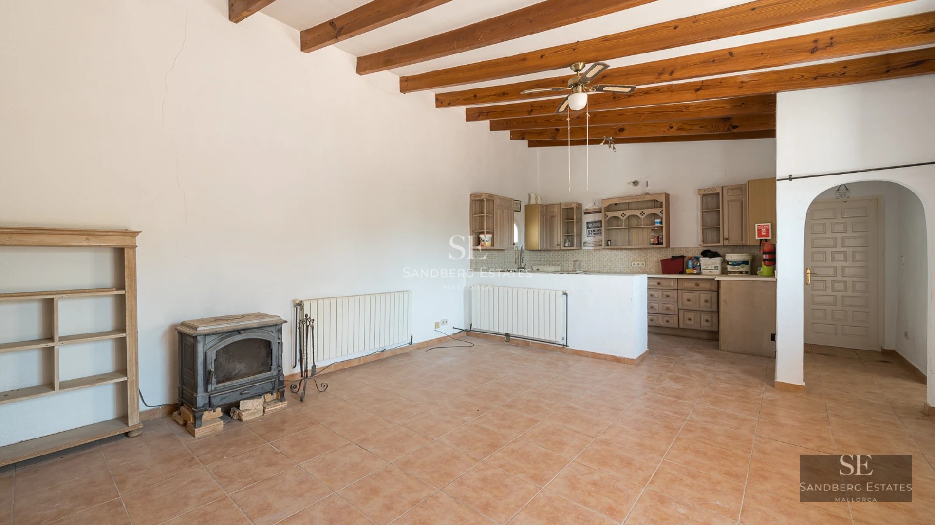 Spacious pool with sunny terrace, sun loungers, and lush greenery. Modern architecture with large windows.