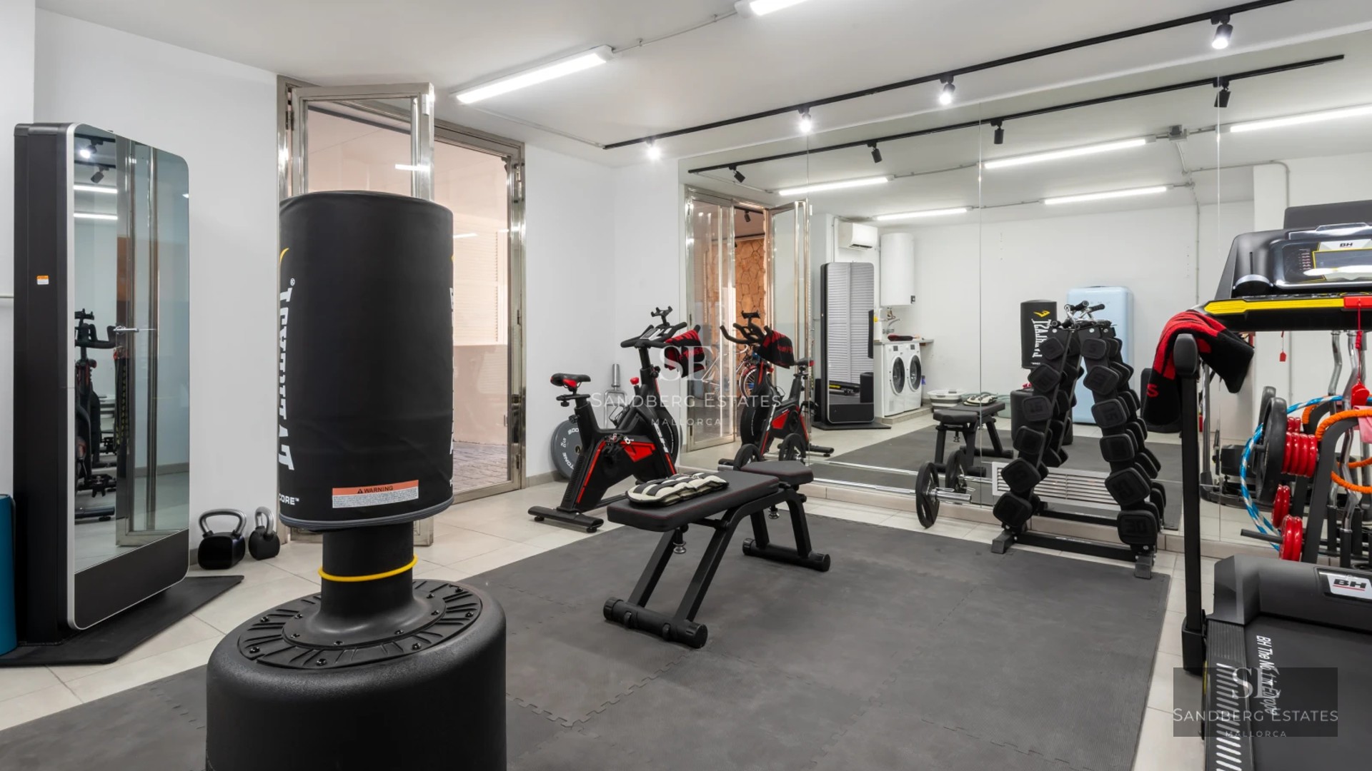 View of modern infinity pool, surrounded by garden and terrace. Minimalist architecture with large windows.