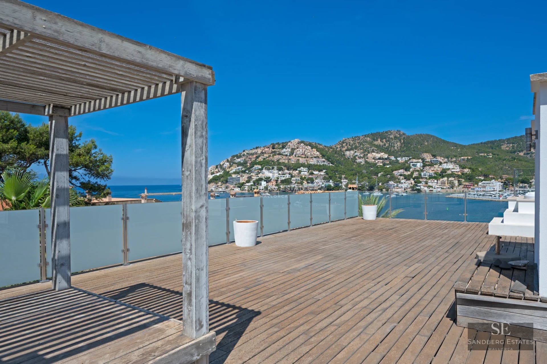 Exterior view of a modern home with a pool. Minimalist architecture, large windows, and lush natural surroundings.