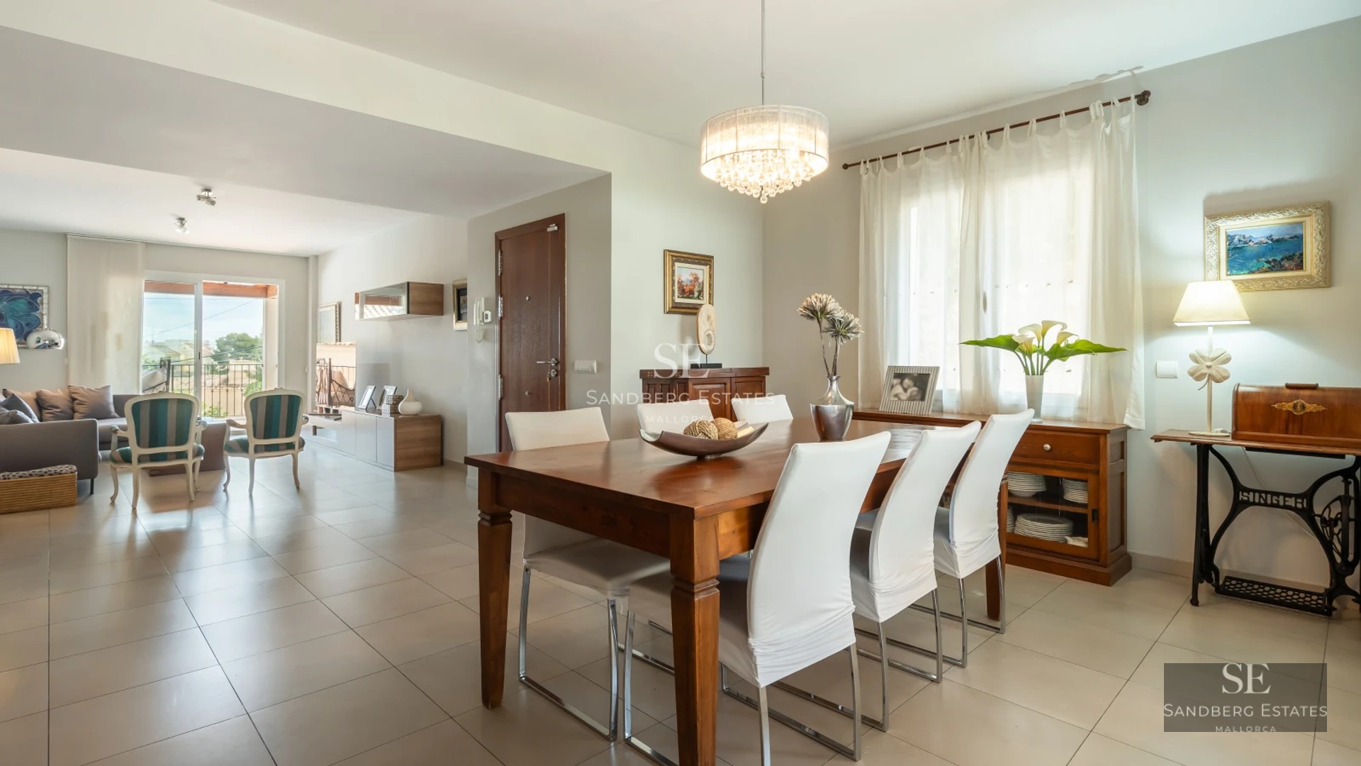 Exterior view of a modern villa with pool, large garden and minimalist architectural design. White facade with large windows.