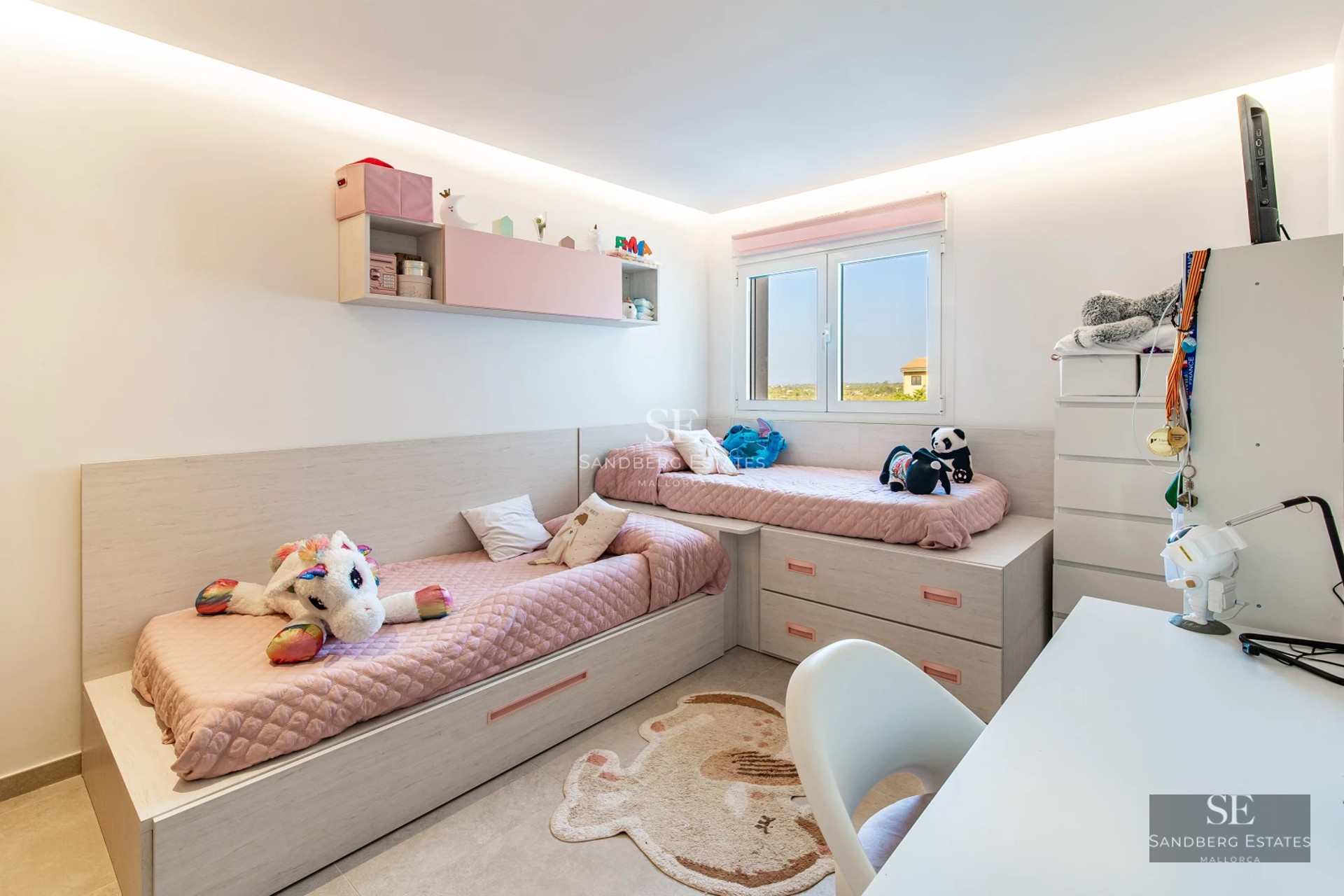 Spacious living room featuring large windows, a modern fireplace, light wood floors, and panoramic outdoor views. Designer sofas and minimalist decor.