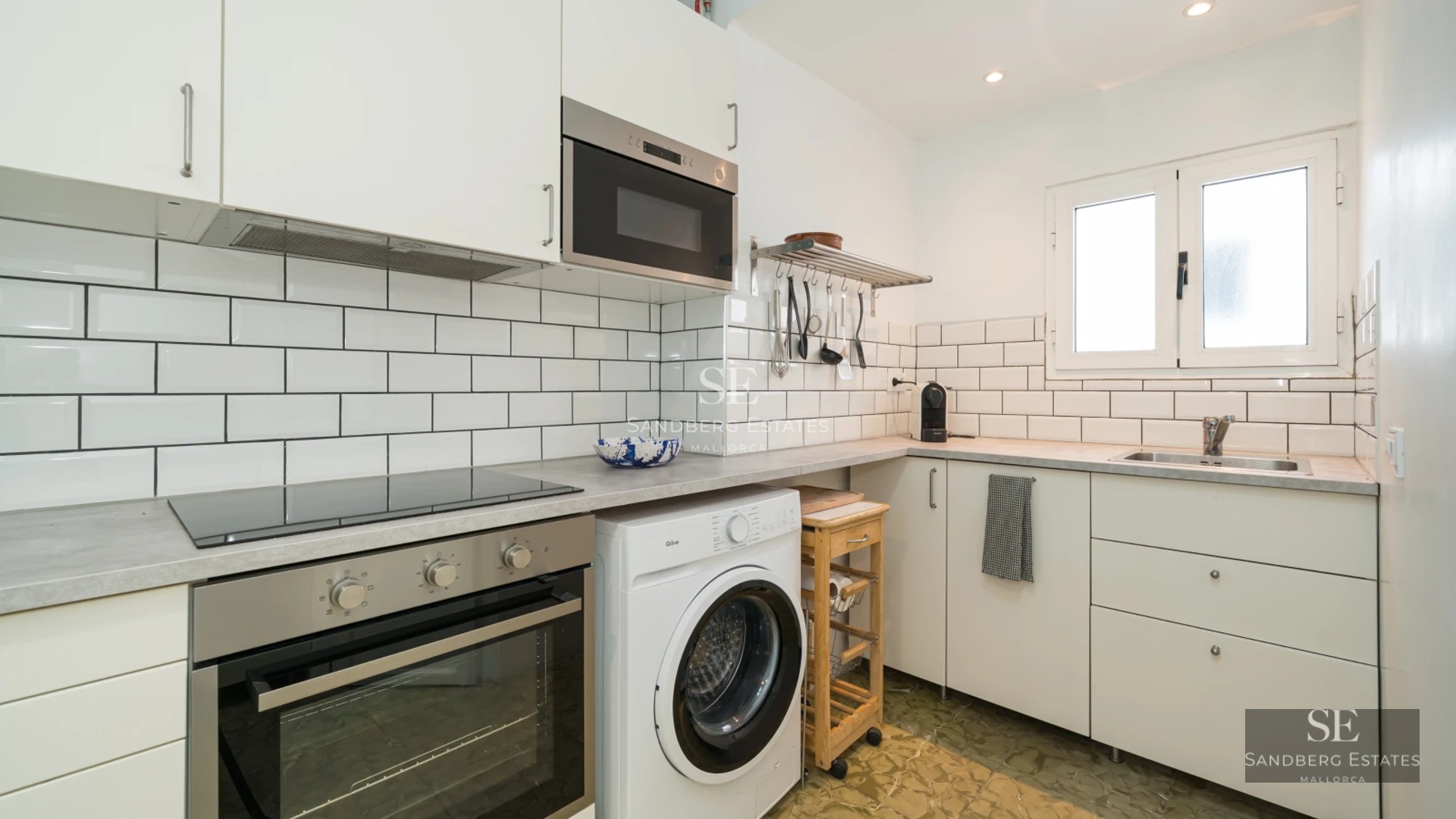 Spacious living room with pool visible through window walls. Modern design, neutral colors, and abundant natural light. Elegant and minimalist furniture.