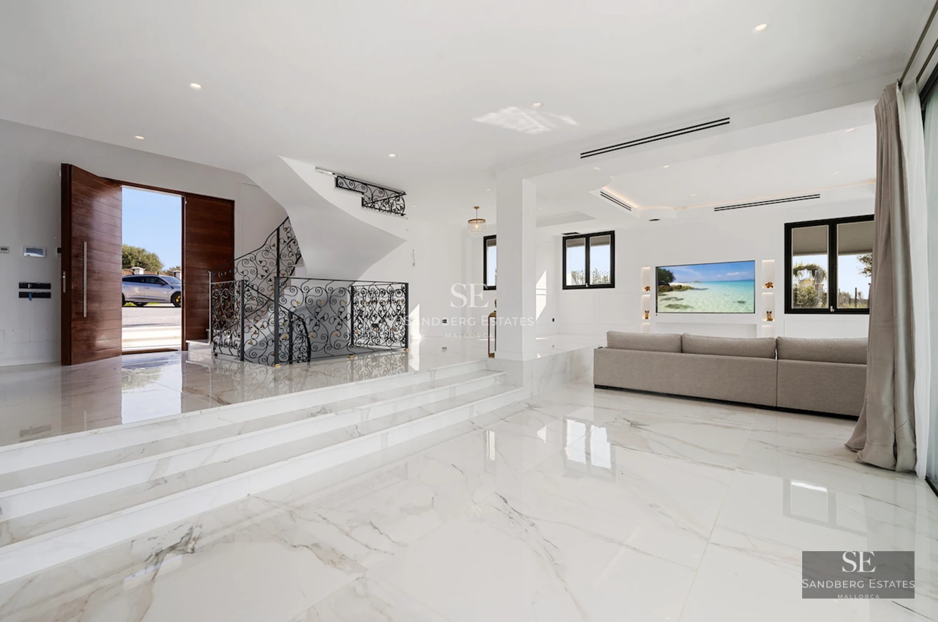 Exterior view of a modern villa with infinity pool, lush gardens, and minimalist architectural design with large window panes.