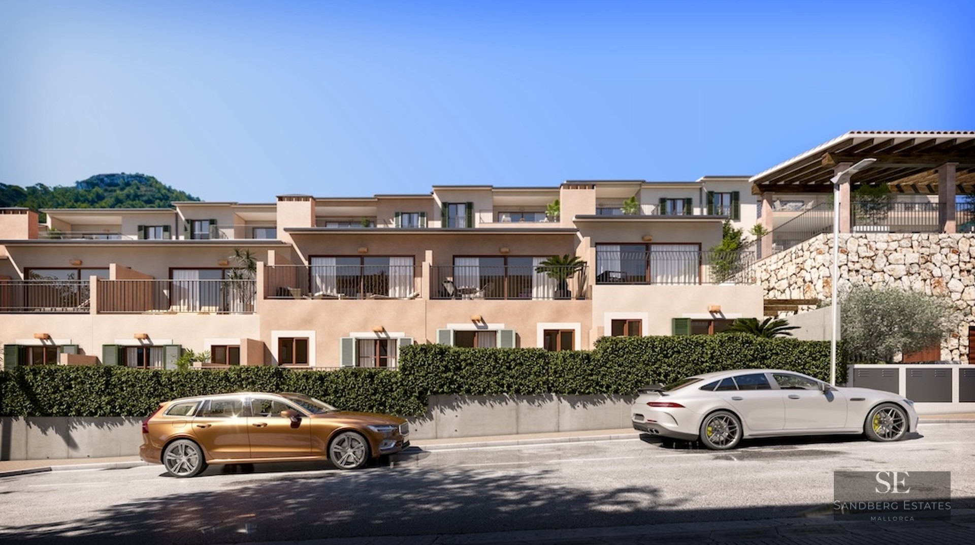 Exterior view of modern multi-level Mediterranean residences with stone walls, balconies, and cars parked on the street.