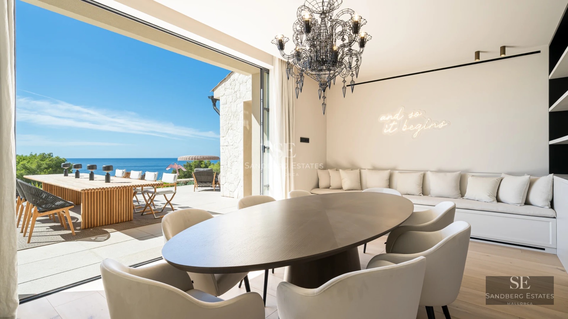 Bright living room with large windows, sea view, stylish sofa, and modern decor. Spacious and luxurious space.