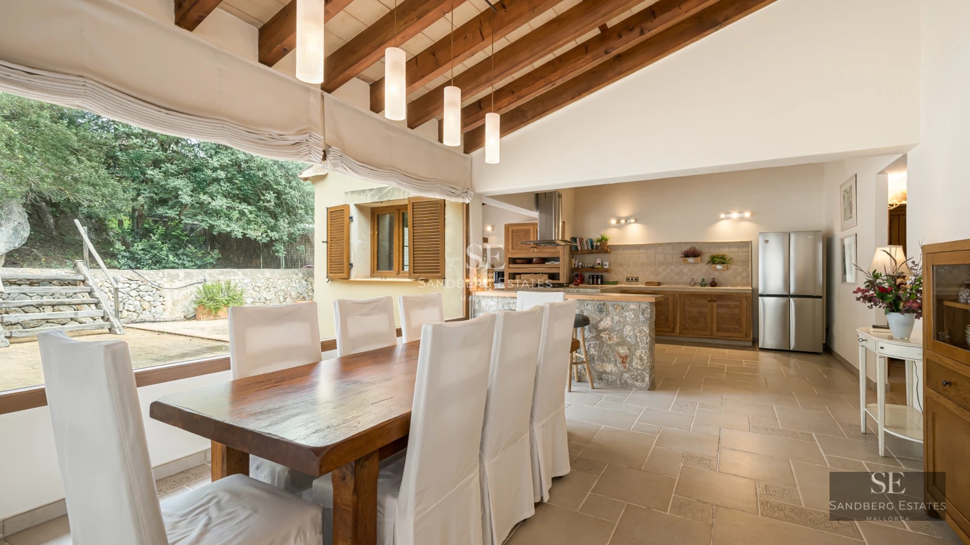 Rectangular infinity pool. Panoramic views. Light tiles, lounge area with sunbeds. Blue sky reflected in the water.