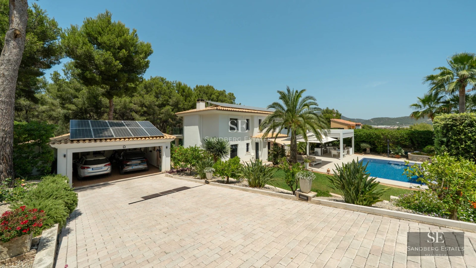 Modern apartment featuring a glass-enclosed balcony with panoramic sea views. Sleek, minimalist design with wood and stone accents.